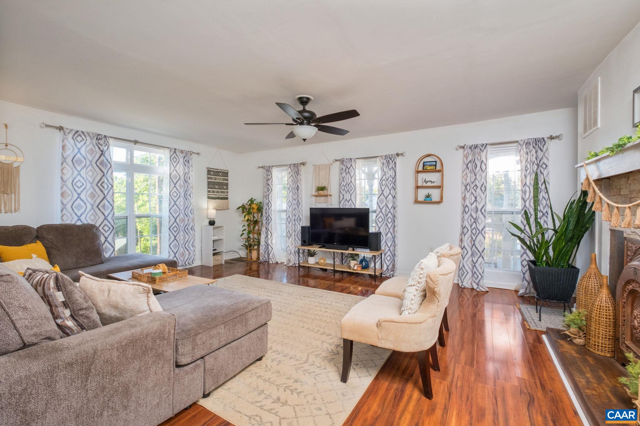 Light-filled living room features beautiful fireplace accent wall. Light-filled living room features beautiful fireplace accent wall.