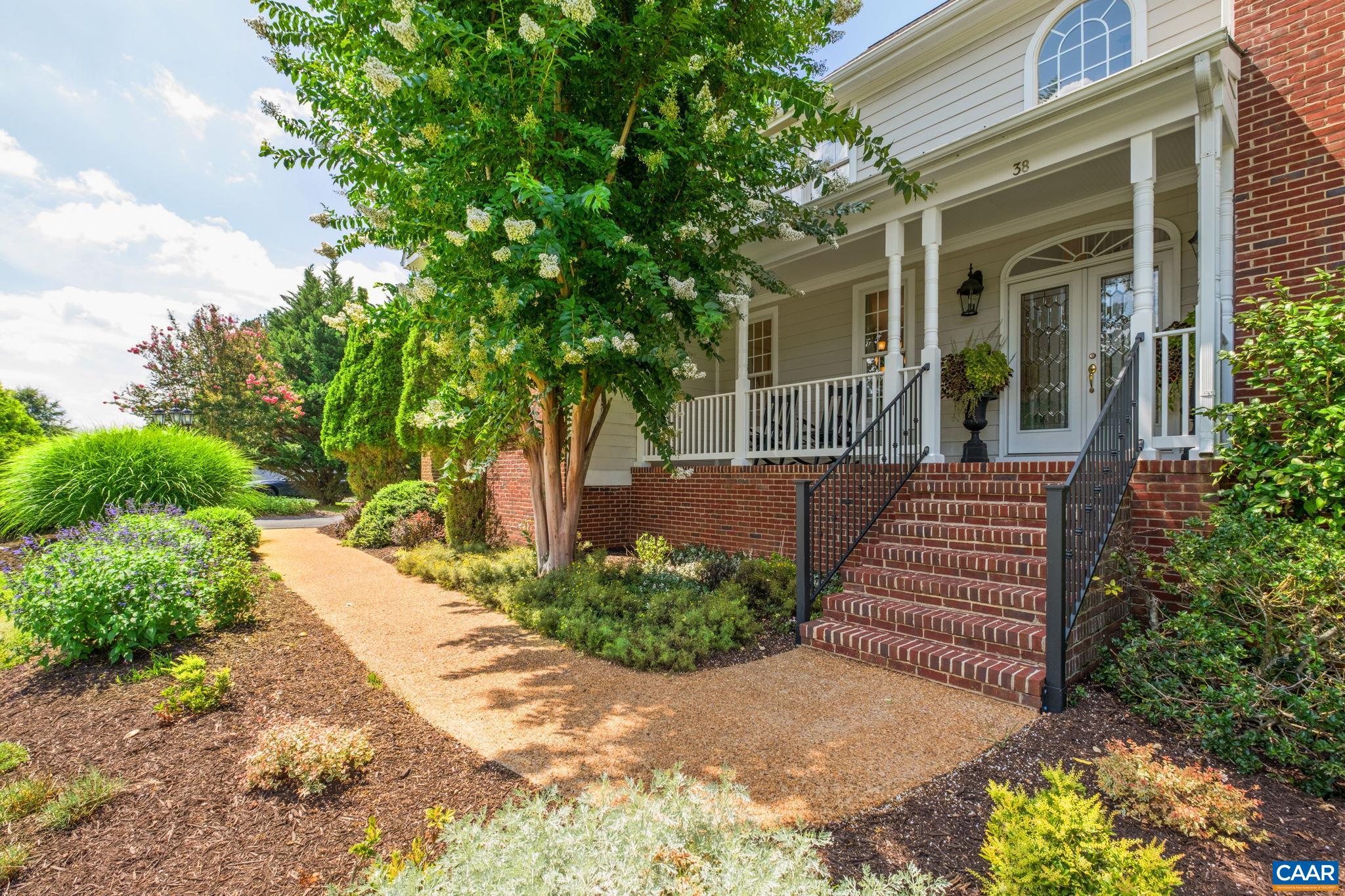 A water fountain and aggregate sidewalk welcome you to the front porch. Showcase features include an aggregate porch trimmed in brick, new metal stair railing, and exterior French doors. Mature landscaping offers some privacy. A water fountain and aggregate sidewalk welcome you to the front porch. Showcase features include an aggregate porch trimmed in brick, new metal stair railing, and exterior French doors. Mature landscaping offers some privacy.