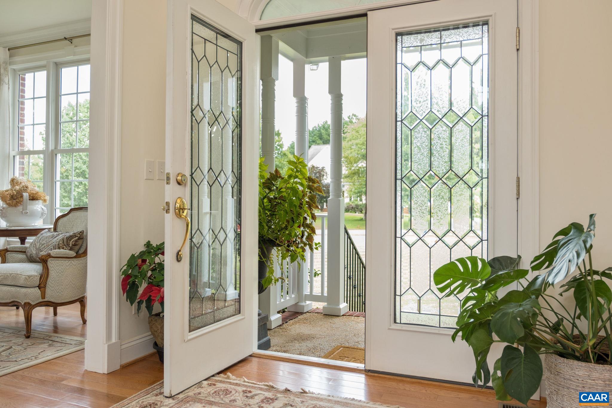 French doors with transom window welcome you to the spacious foyer. Home features hardwood floors throughout. French doors with transom window welcome you to the spacious foyer. Home features hardwood floors throughout.