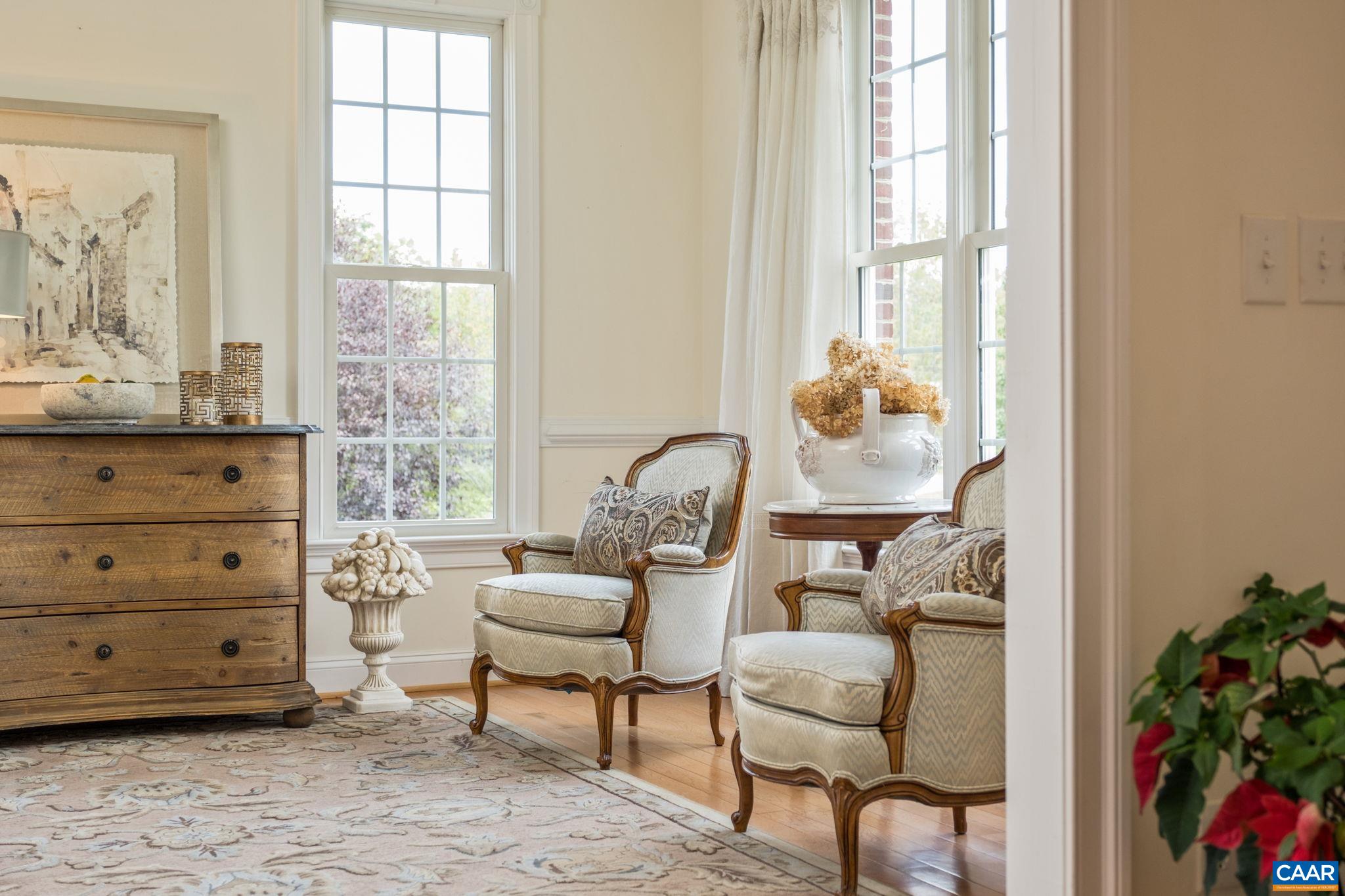 Sitting room features hardwood floors, crown molding, and chair railing. Sitting room features hardwood floors, crown molding, and chair railing.