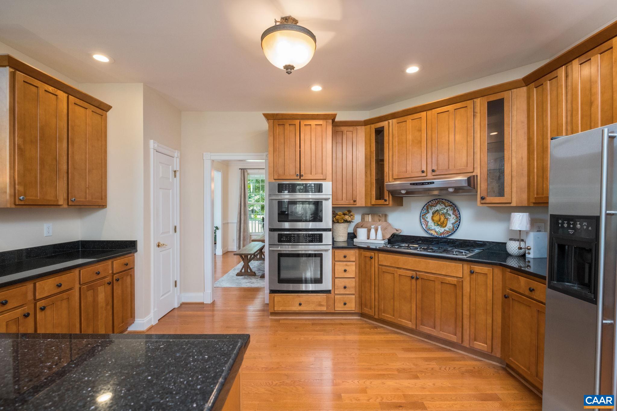 The kitchen features cherry cabinetry, granite countertops, a pantry, gas cooktop, a breakfast bar, and a breakfast nook. The kitchen features cherry cabinetry, granite countertops, a pantry, gas cooktop, a breakfast bar, and a breakfast nook.