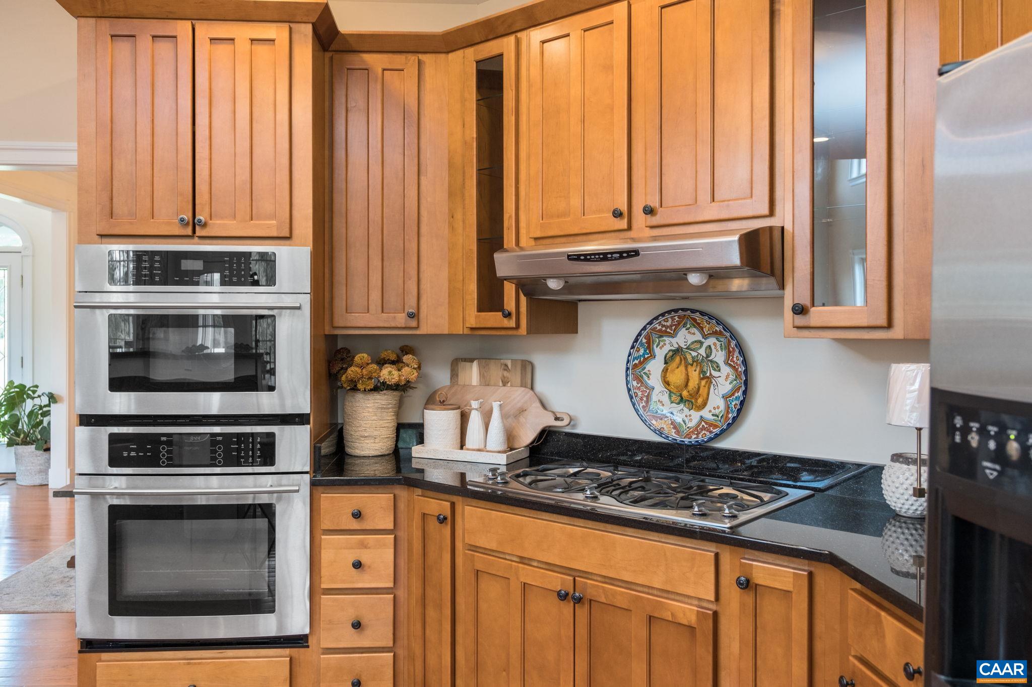 The wall oven, microwave, and gas cooktop are in view. The wall oven, microwave, and gas cooktop are in view.