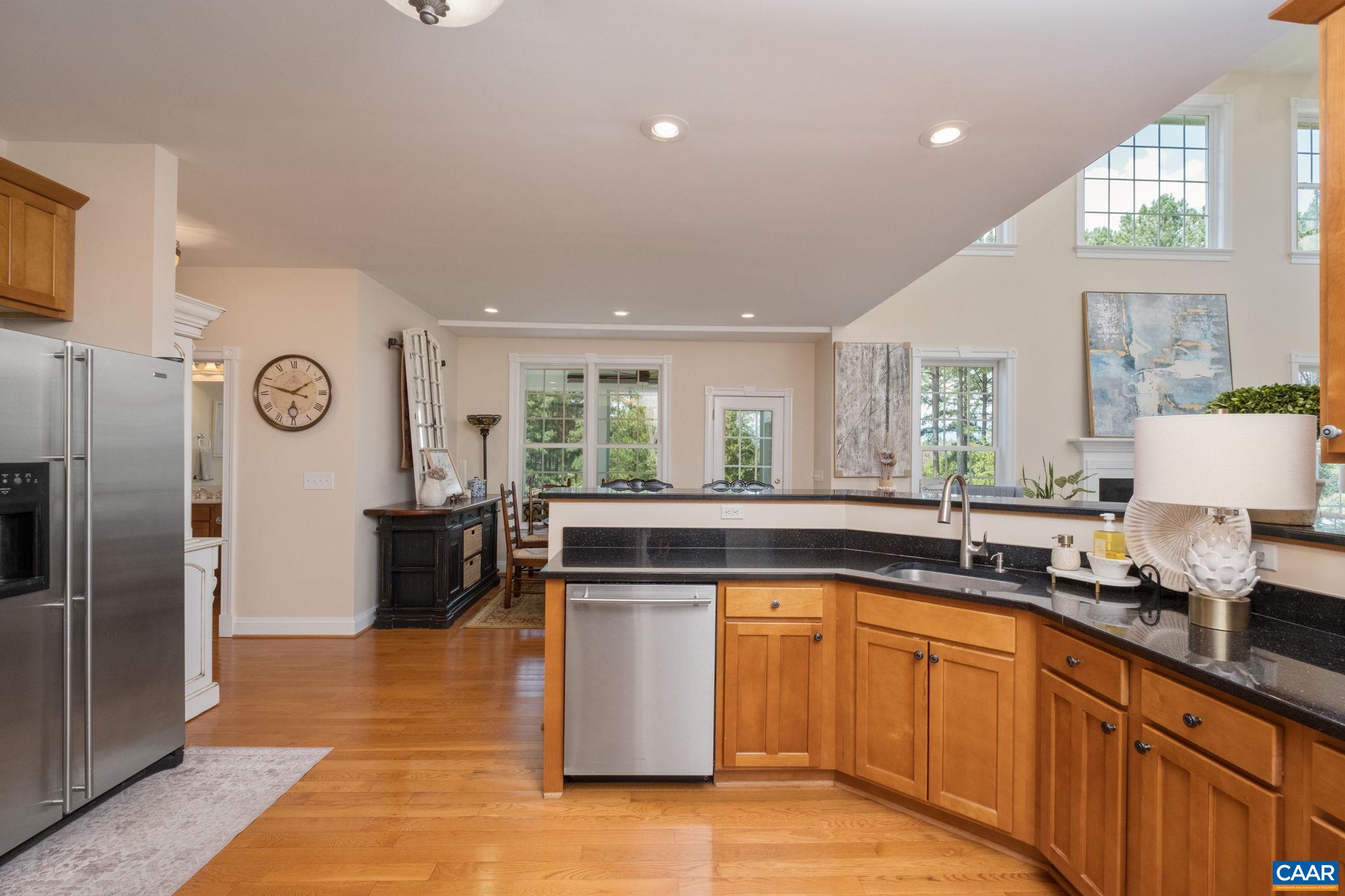 The kitchen overlooks the breakfast nook, great room, and the new sunroom. The kitchen overlooks the breakfast nook, great room, and the new sunroom.