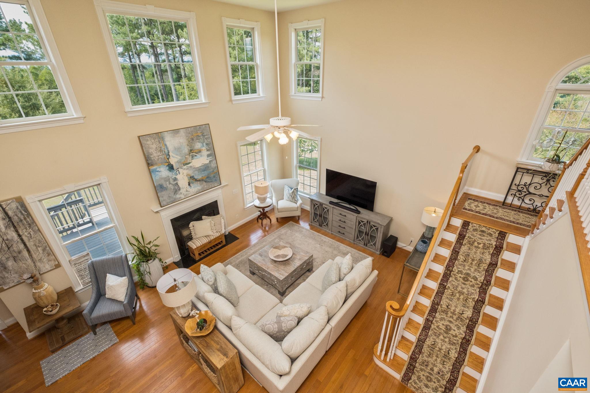 The great room features plenty of windows for natural light, a gas log fireplace, and has easy access to the kitchen and sunroom. The great room features plenty of windows for natural light, a gas log fireplace, and has easy access to the kitchen and sunroom.