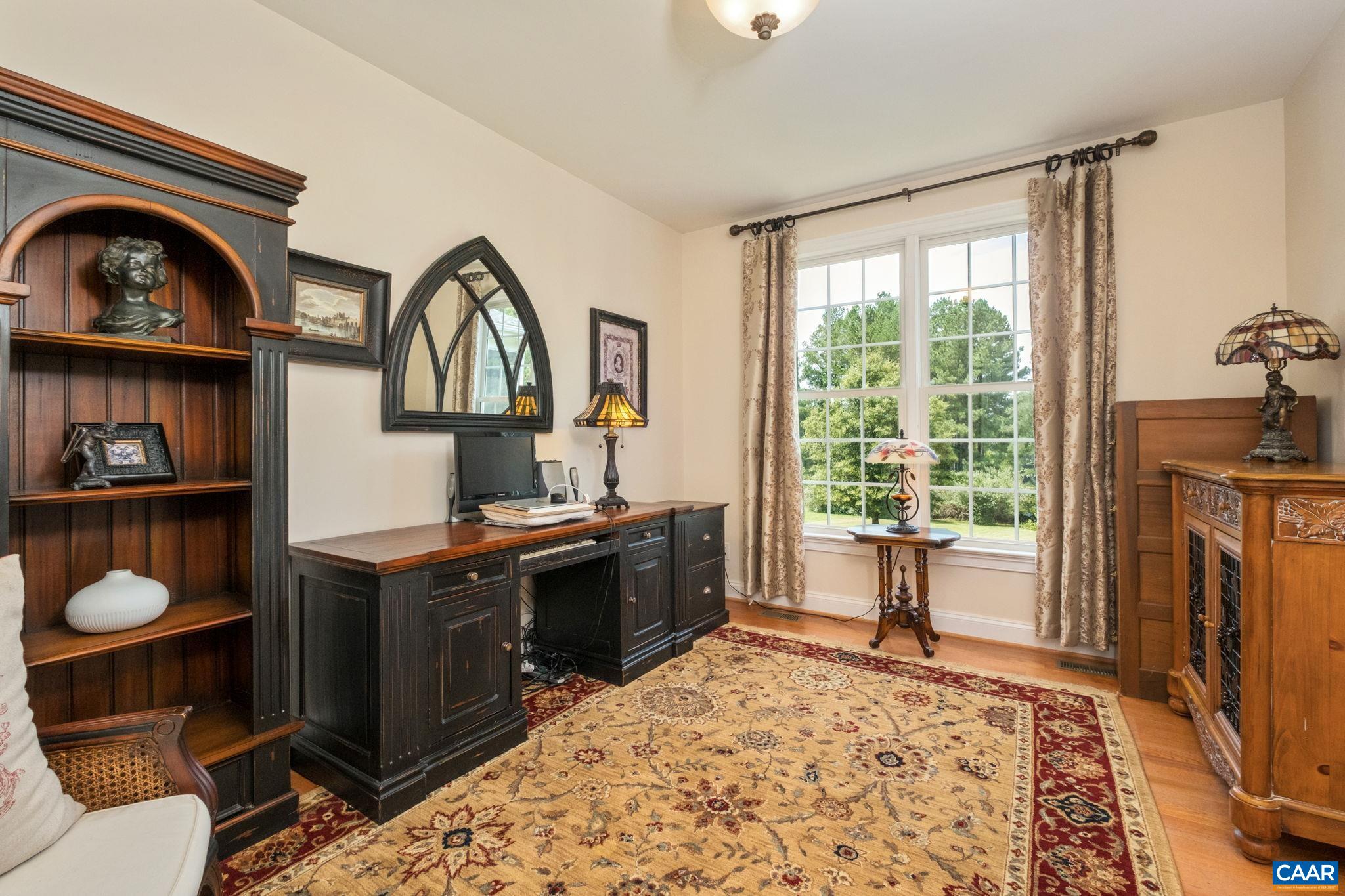 This main level bedroom is located on the back side of the home closest to the garage, with an adjacent full bathroom. Owners use this room as an office. This main level bedroom is located on the back side of the home closest to the garage, with an adjacent full bathroom. Owners use this room as an office.