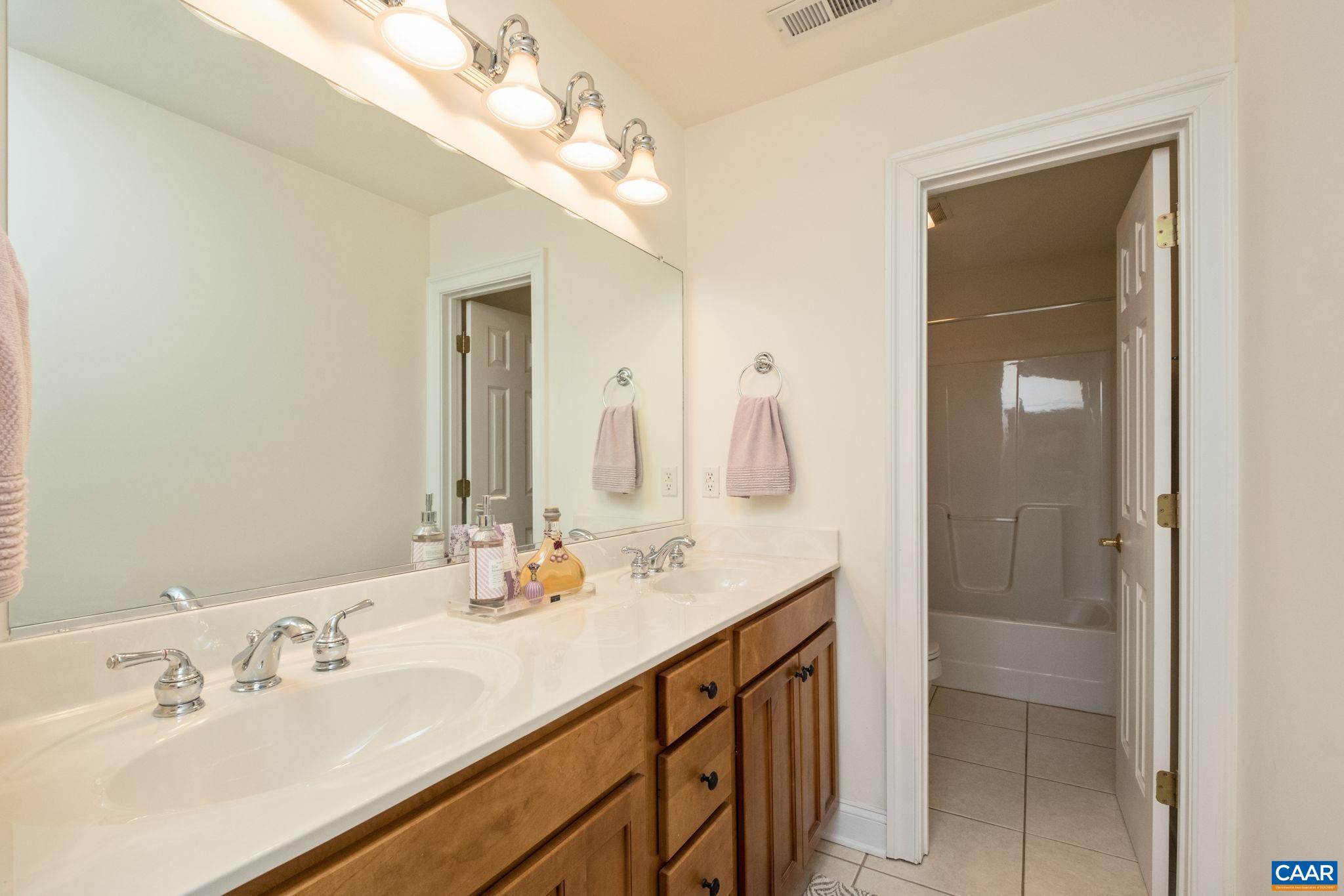 This full bathroom is located in the hallway of the 2nd level. The dual vanity sinks and linen closet are separated by a door to the rest of the bathroom. This full bathroom is located in the hallway of the 2nd level. The dual vanity sinks and linen closet are separated by a door to the rest of the bathroom.