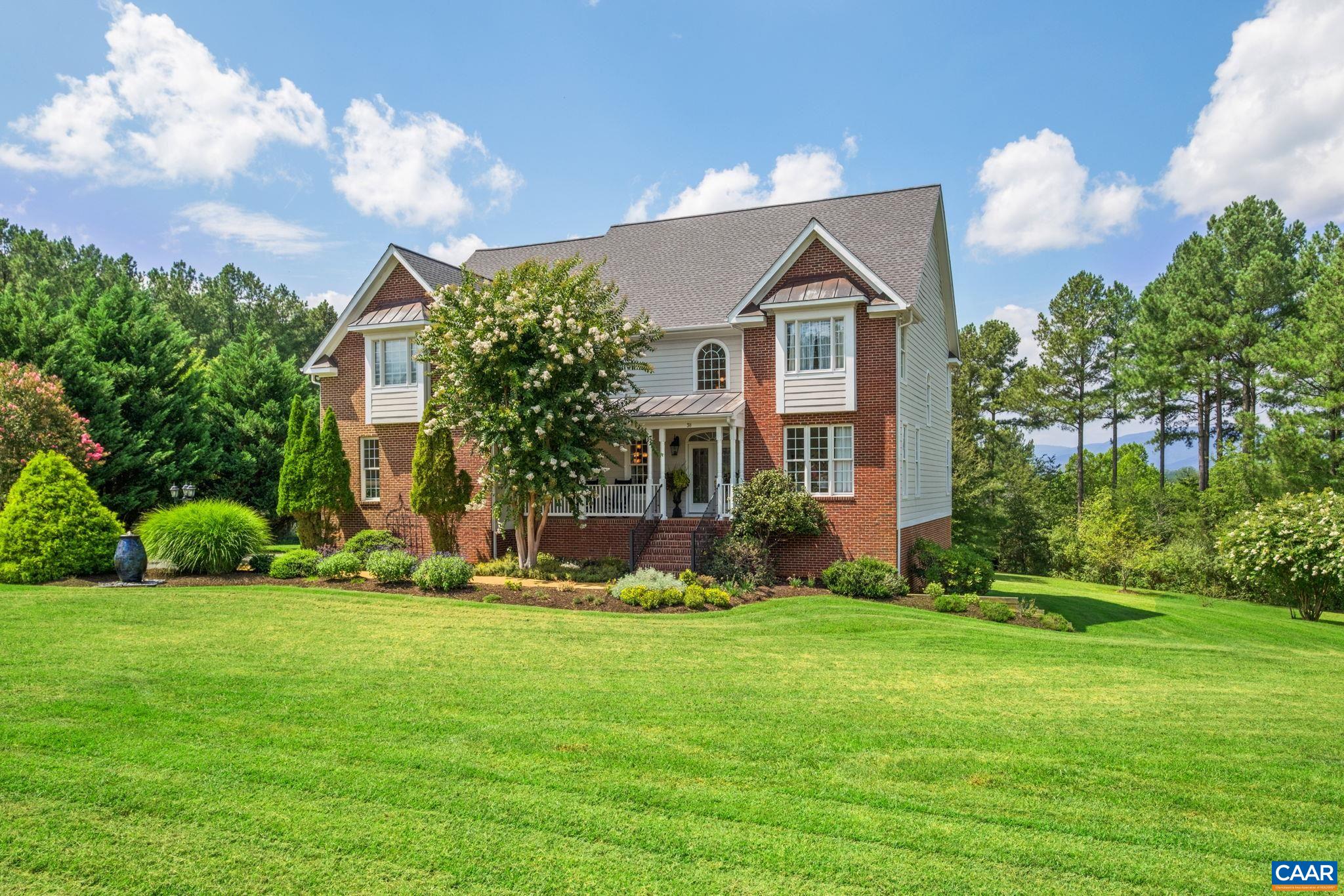 This property showcases the new roof, a covered front porch, and a water fountain by the driveway. This property showcases the new roof, a covered front porch, and a water fountain by the driveway.