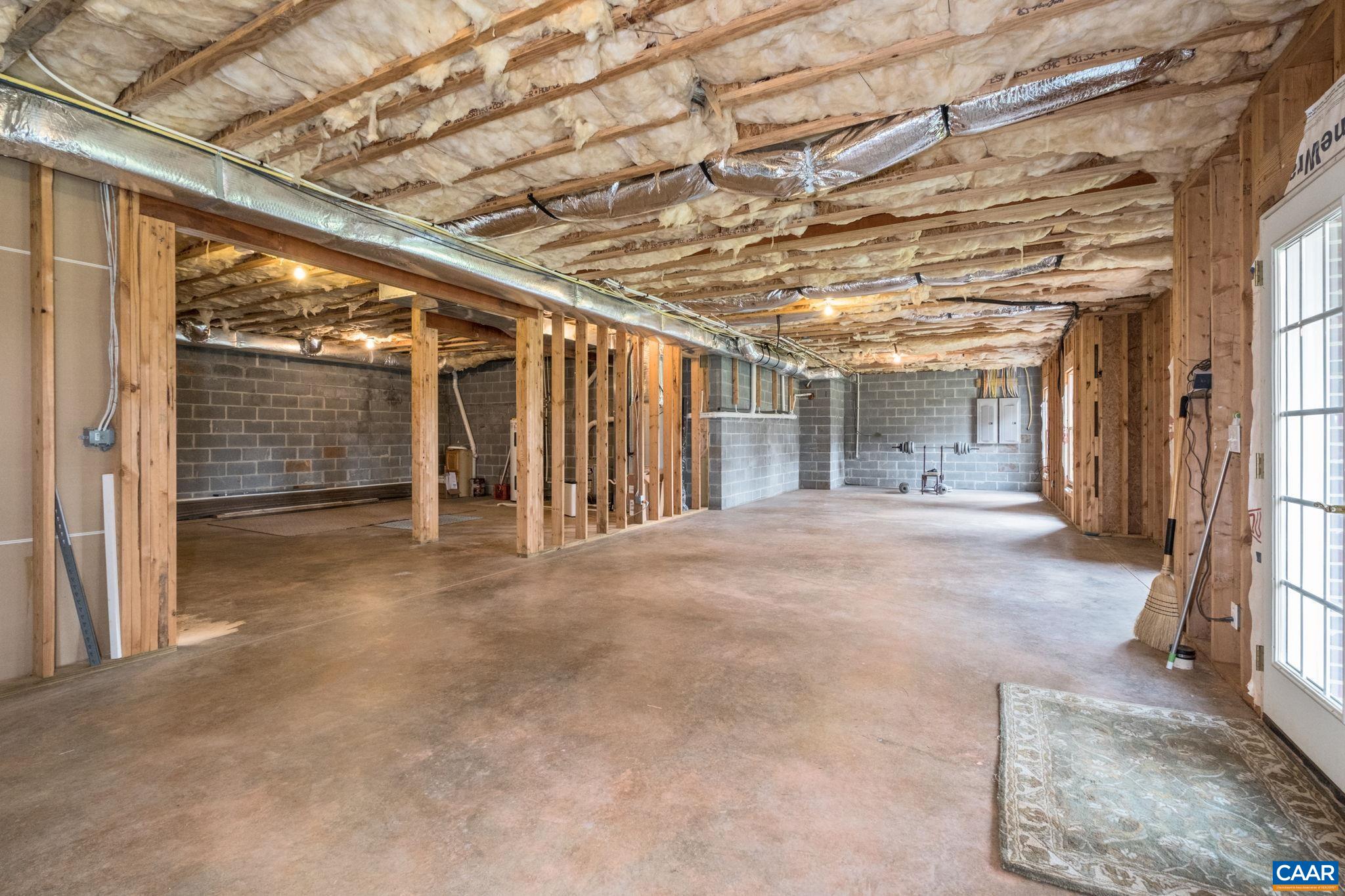 The unfinished basement offers natural light from the windows and French doors. The unfinished basement offers natural light from the windows and French doors.