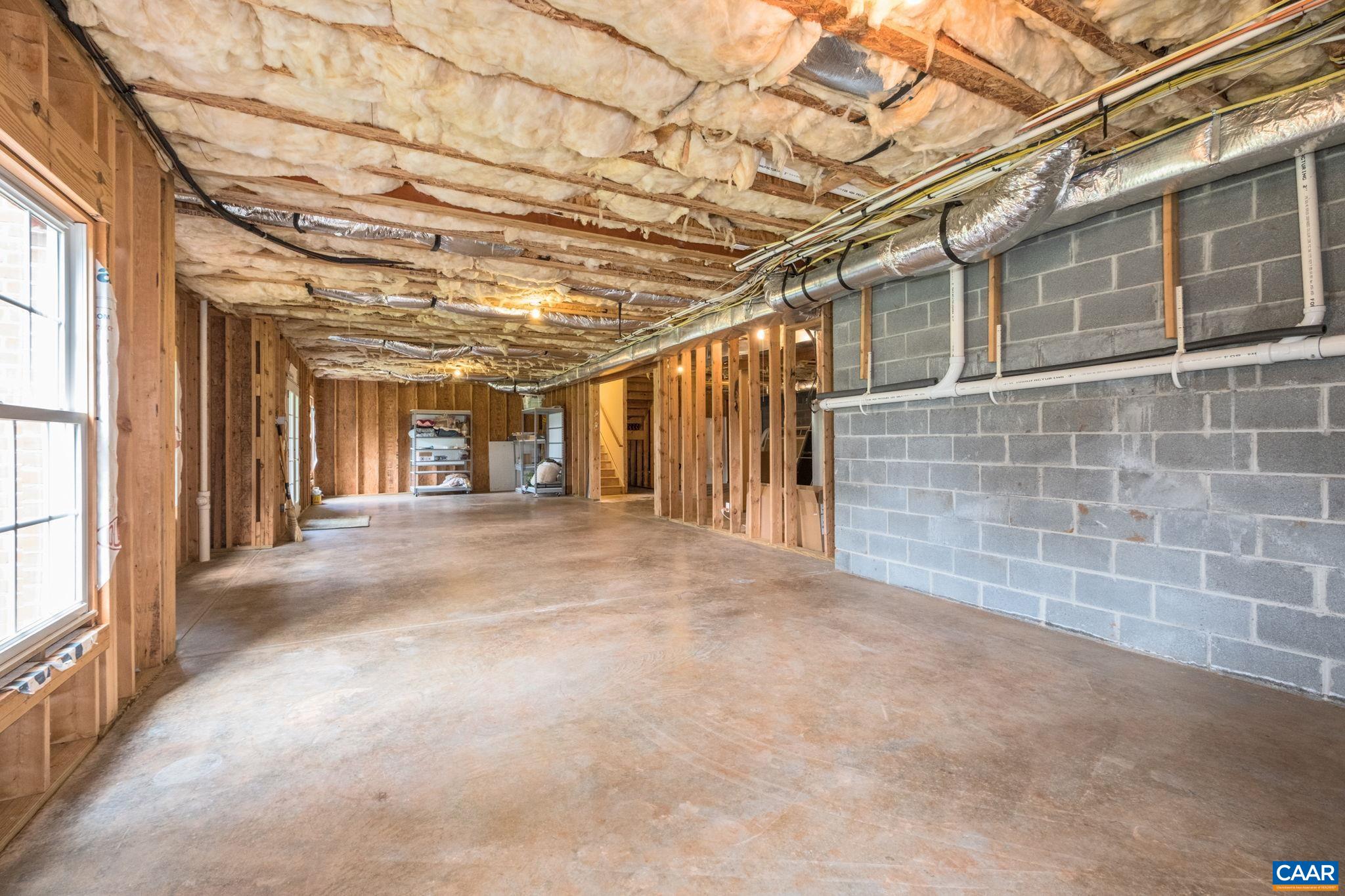 The unfinished basement offers natural light from the windows and French doors. The unfinished basement offers natural light from the windows and French doors.