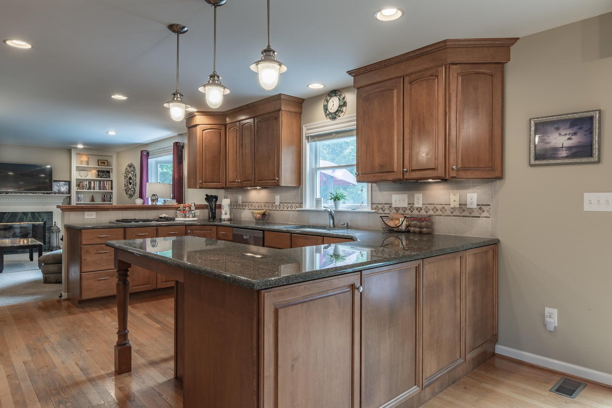 The kitchen features granite counter tops . . . The kitchen features granite counter tops . . .