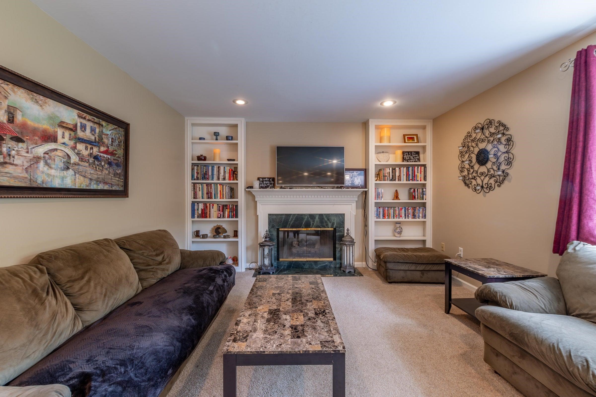 Family room offers a cozy fireplace and built-in book shelves. Family room offers a cozy fireplace and built-in book shelves.