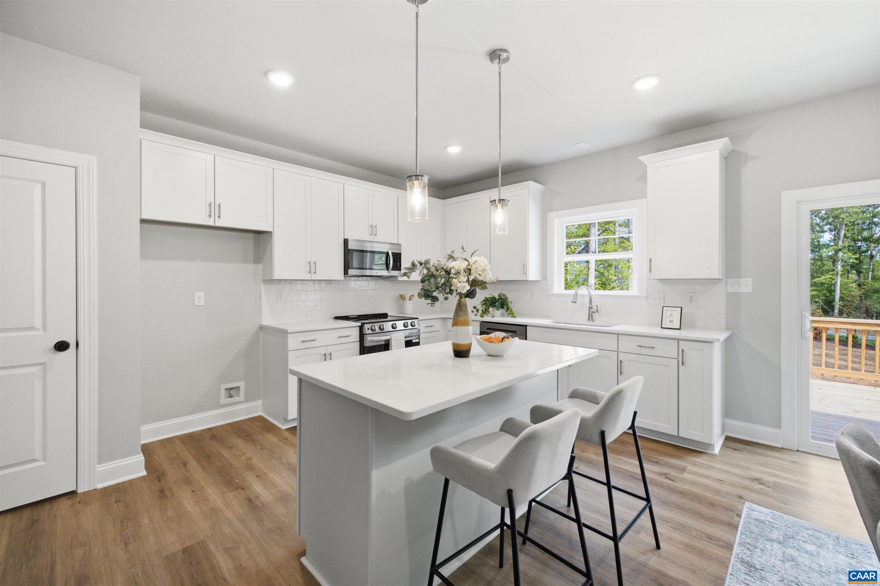 Kitchen will have upgraded cabinets, quartz counters, walk-in pantry, SS dishwasher, stove and microwave. Lots of light! Photo of a staged home. Kitchen will have upgraded cabinets, quartz counters, walk-in pantry, SS dishwasher, stove and microwave. Lots of light! Photo of a staged home.