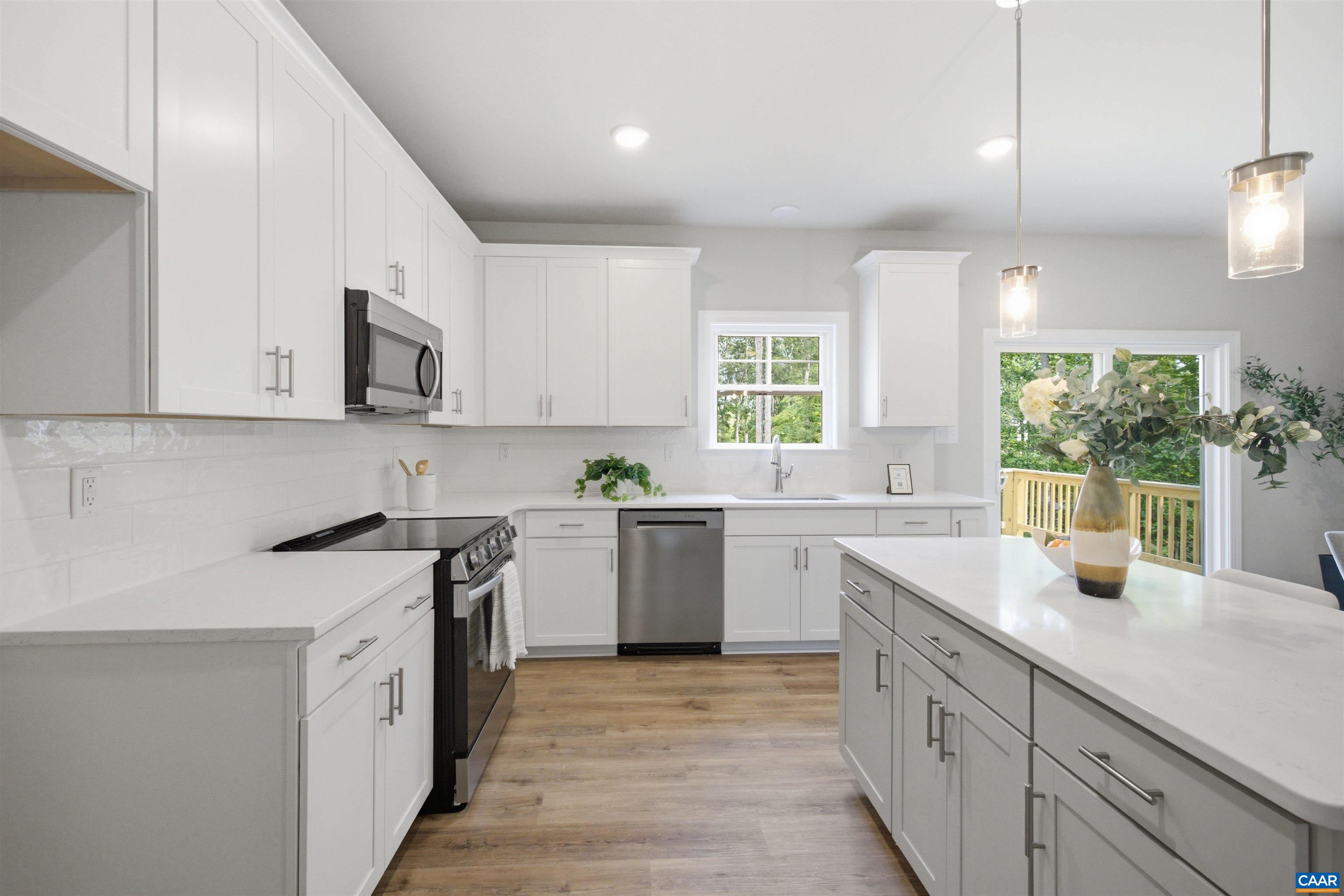 Kitchen will have upgraded cabinets, quartz counters, walk-in pantry, SS dishwasher, stove and microwave. Lots of light! Photo of a staged home. Kitchen will have upgraded cabinets, quartz counters, walk-in pantry, SS dishwasher, stove and microwave. Lots of light! Photo of a staged home.