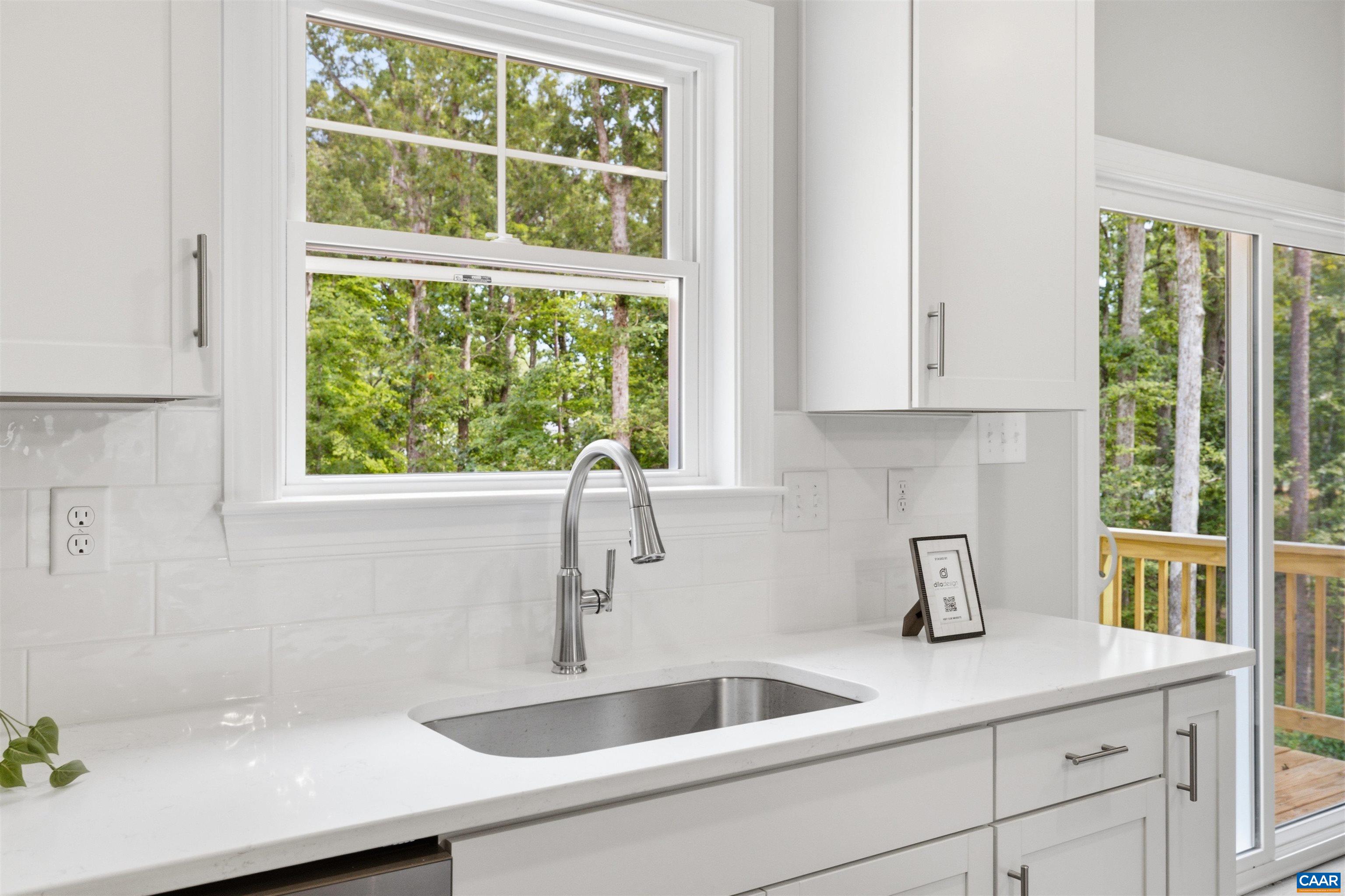Window over kitchen sink, view to backyard. Photo of a staged home. Window over kitchen sink, view to backyard. Photo of a staged home.