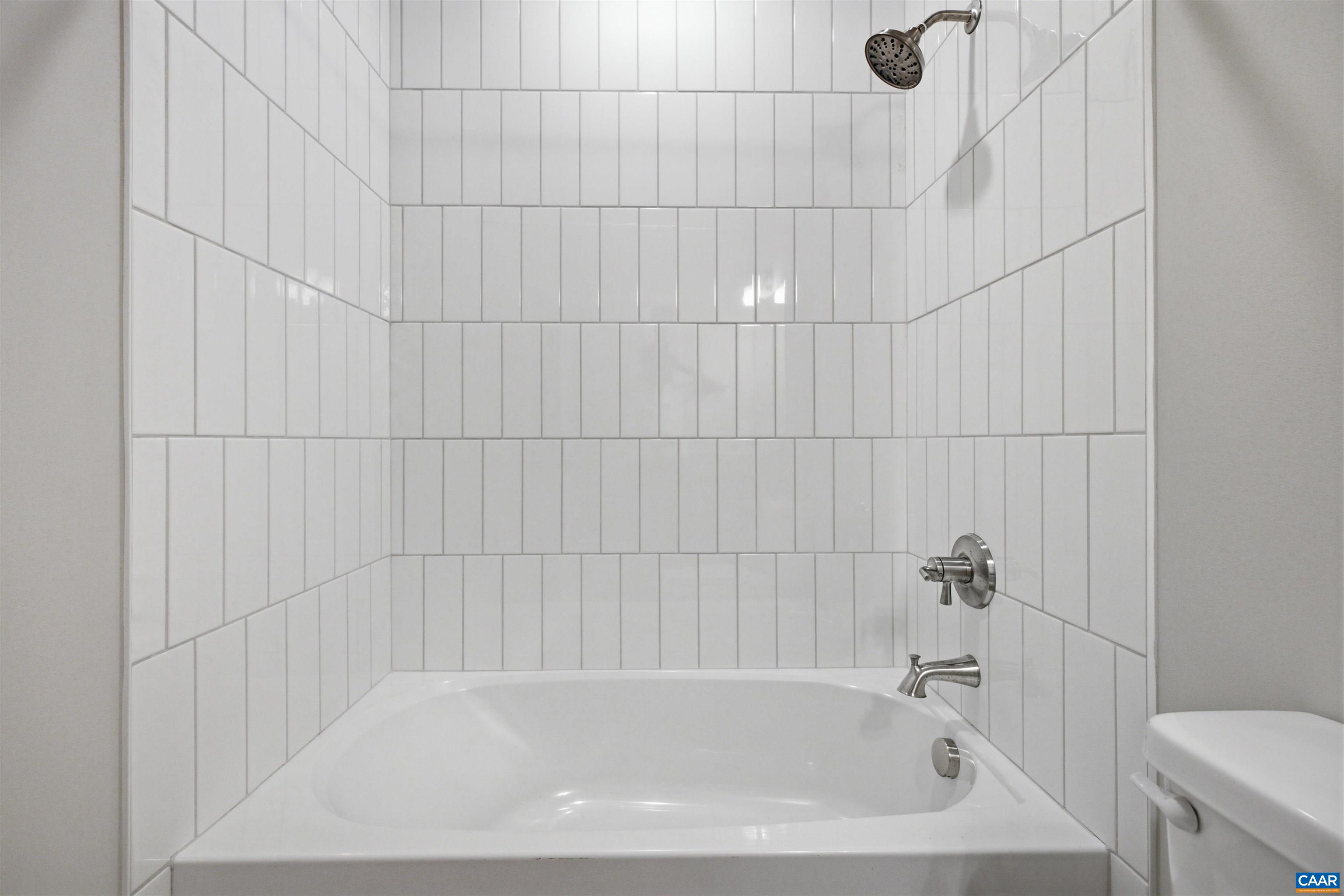 Featuring a tile shower, quartz counters. Featuring a tile shower, quartz counters.