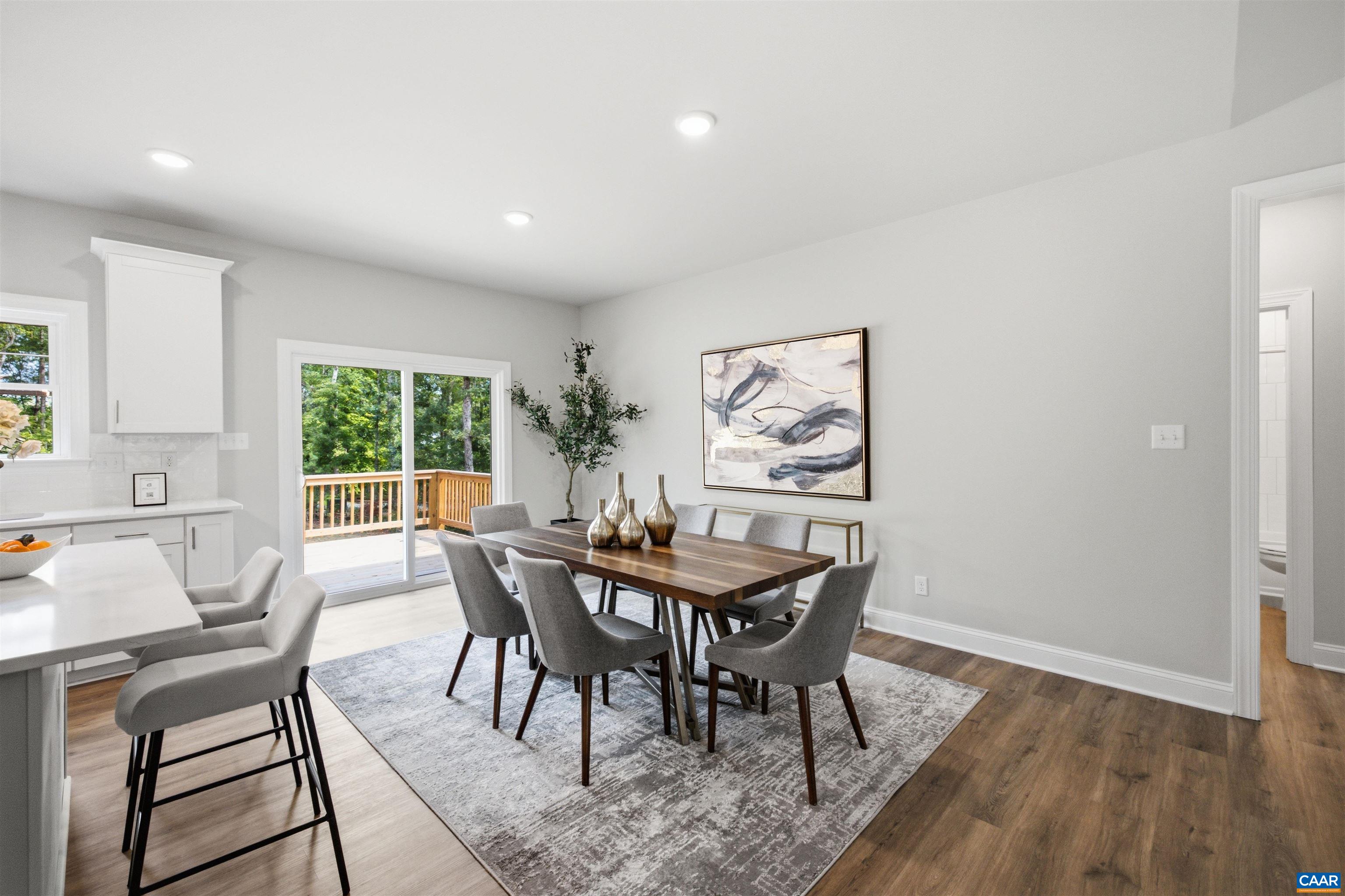 This area will hold a large table. Doors to deck. Photo of a staged home. This area will hold a large table. Doors to deck. Photo of a staged home.