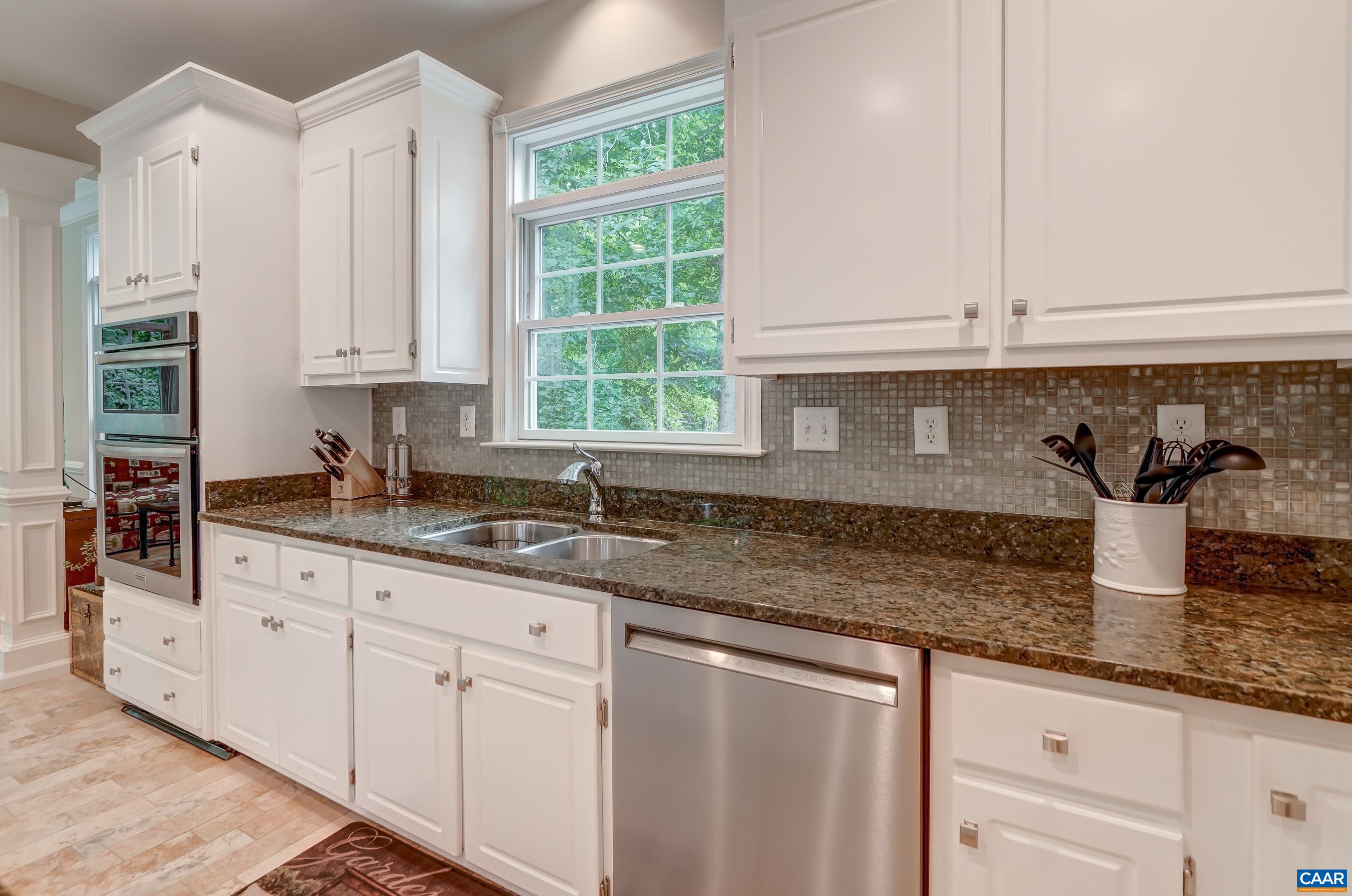 White cabinets and tile backsplash. White cabinets and tile backsplash.