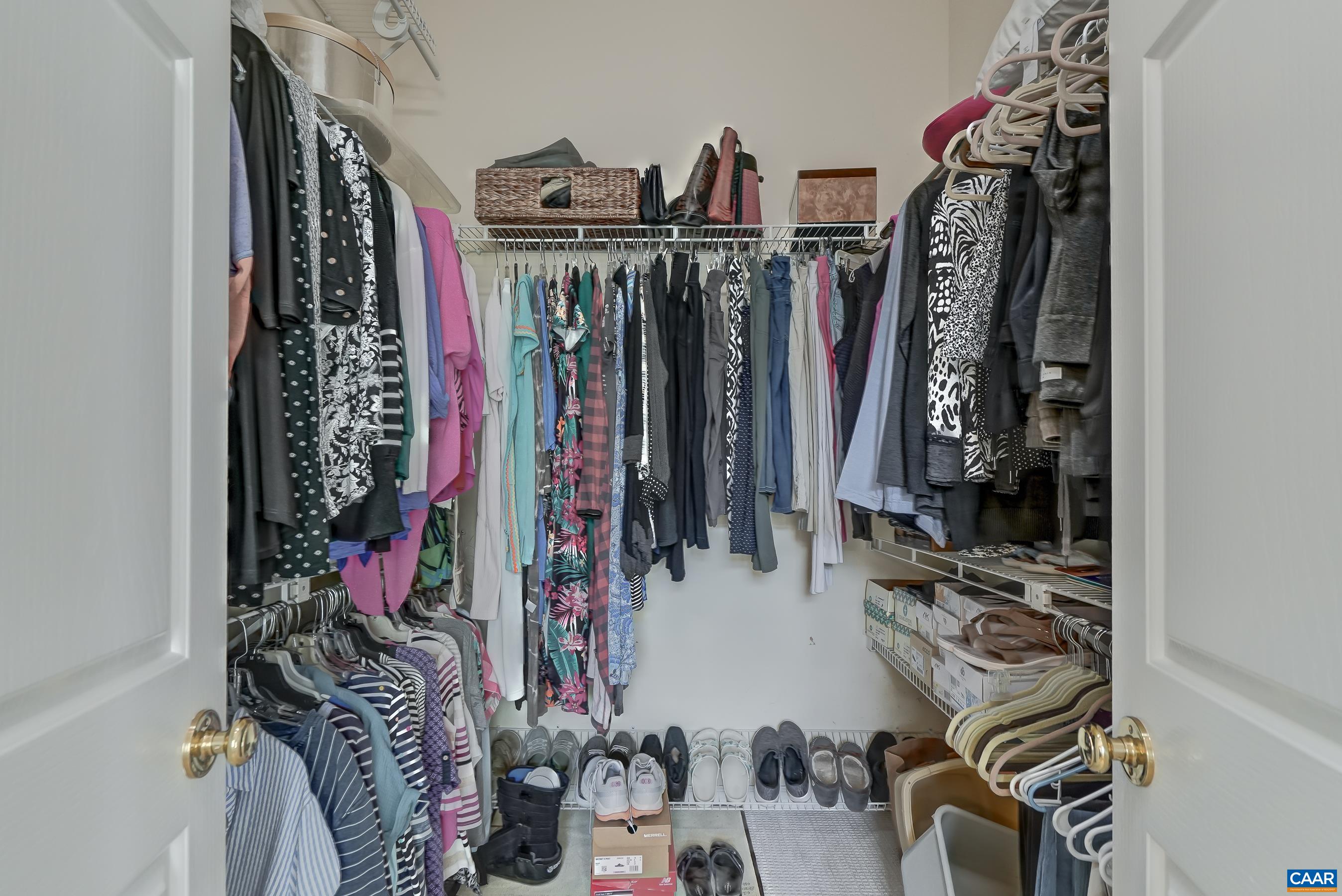 Walk in closet features vaulted ceiling and high storage rack for out of season clothes. Walk in closet features vaulted ceiling and high storage rack for out of season clothes.