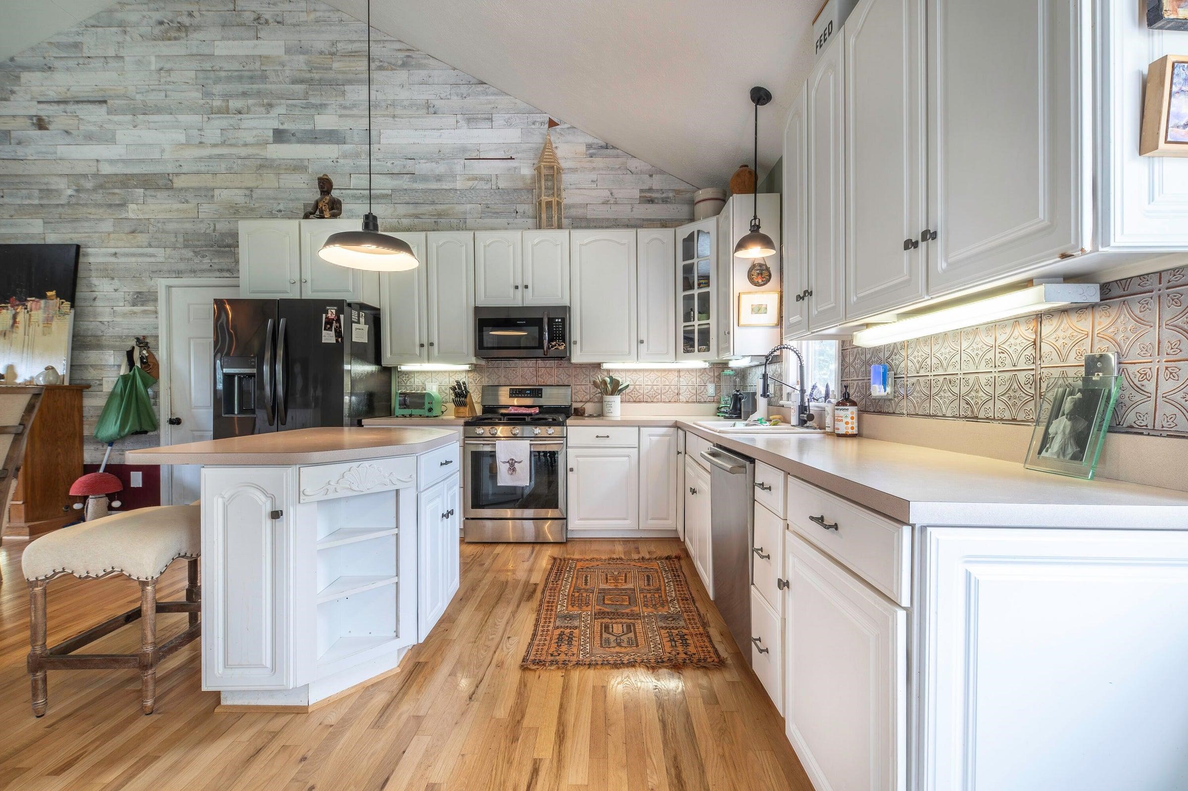 Updated kitchen with custom tin backsplash. Updated kitchen with custom tin backsplash.