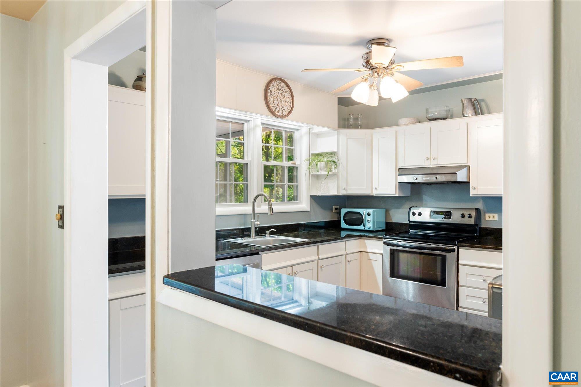 A great layout with white wood cabinets, black granite counters, stainless steel appliances, a pantry & a great view into the back yard. Side door to the driveway makes getting the groceries in easy. A great layout with white wood cabinets, black granite counters, stainless steel appliances, a pantry & a great view into the back yard. Side door to the driveway makes getting the groceries in easy.