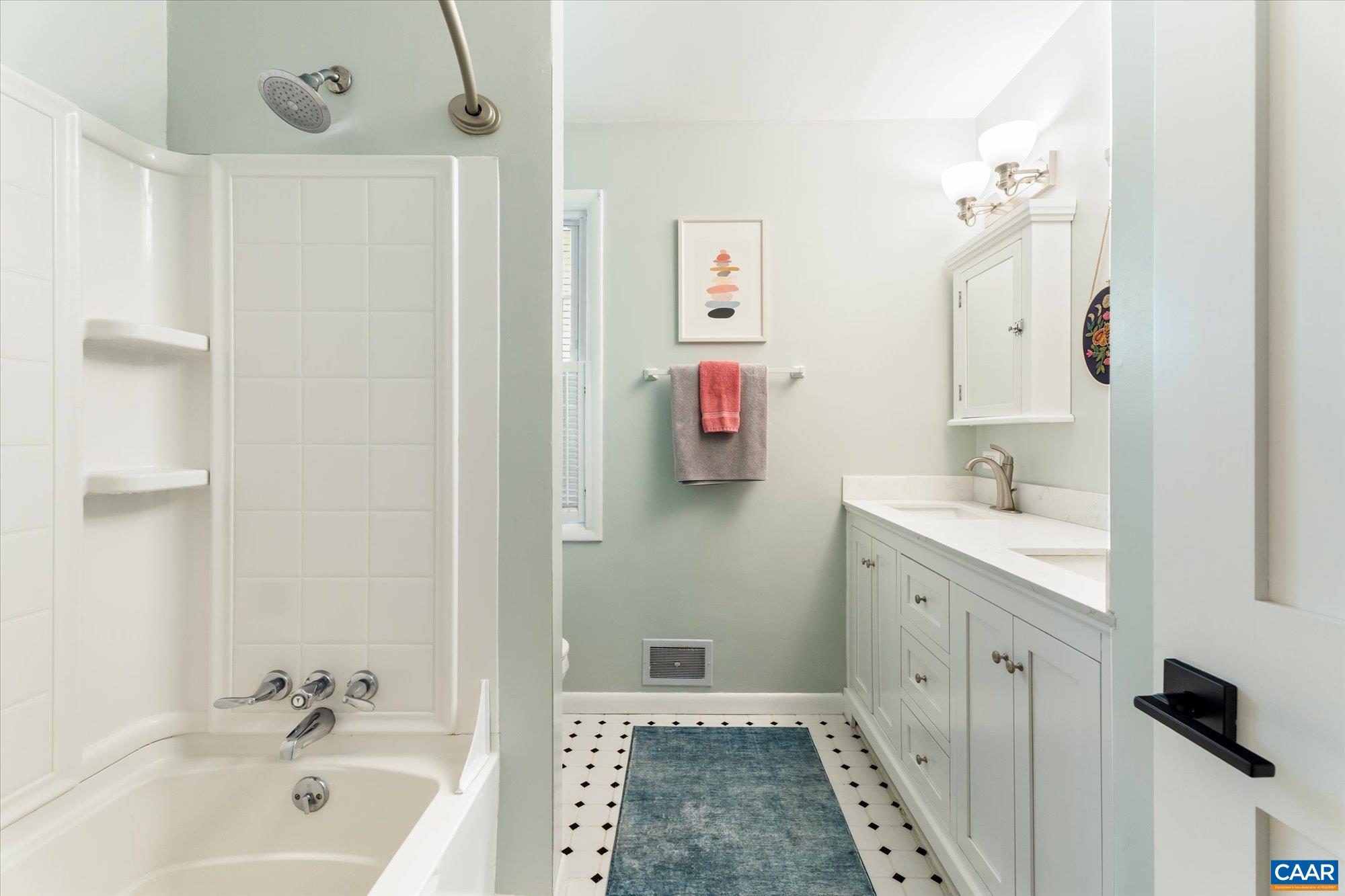 Updated w/ tile floor, quartz counters, double sinks and vanities, medicine cabinets & lighting. Updated w/ tile floor, quartz counters, double sinks and vanities, medicine cabinets & lighting.