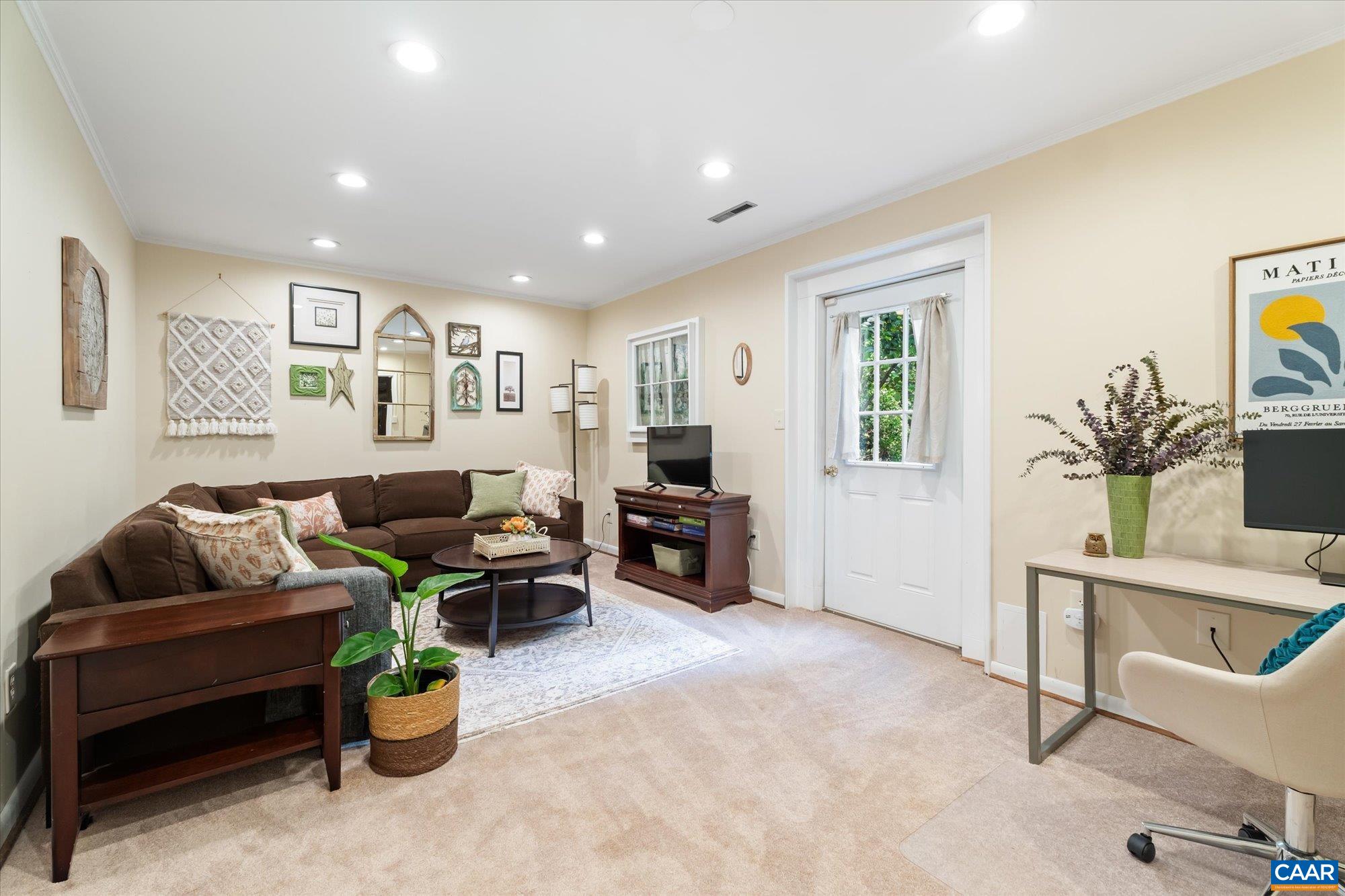 A cozy spot to watch movies & play games. Has an entrance to the outside. Large utility room is connected to this space that accommodates laundry, additional storage and a workshop too! A cozy spot to watch movies & play games. Has an entrance to the outside. Large utility room is connected to this space that accommodates laundry, additional storage and a workshop too!