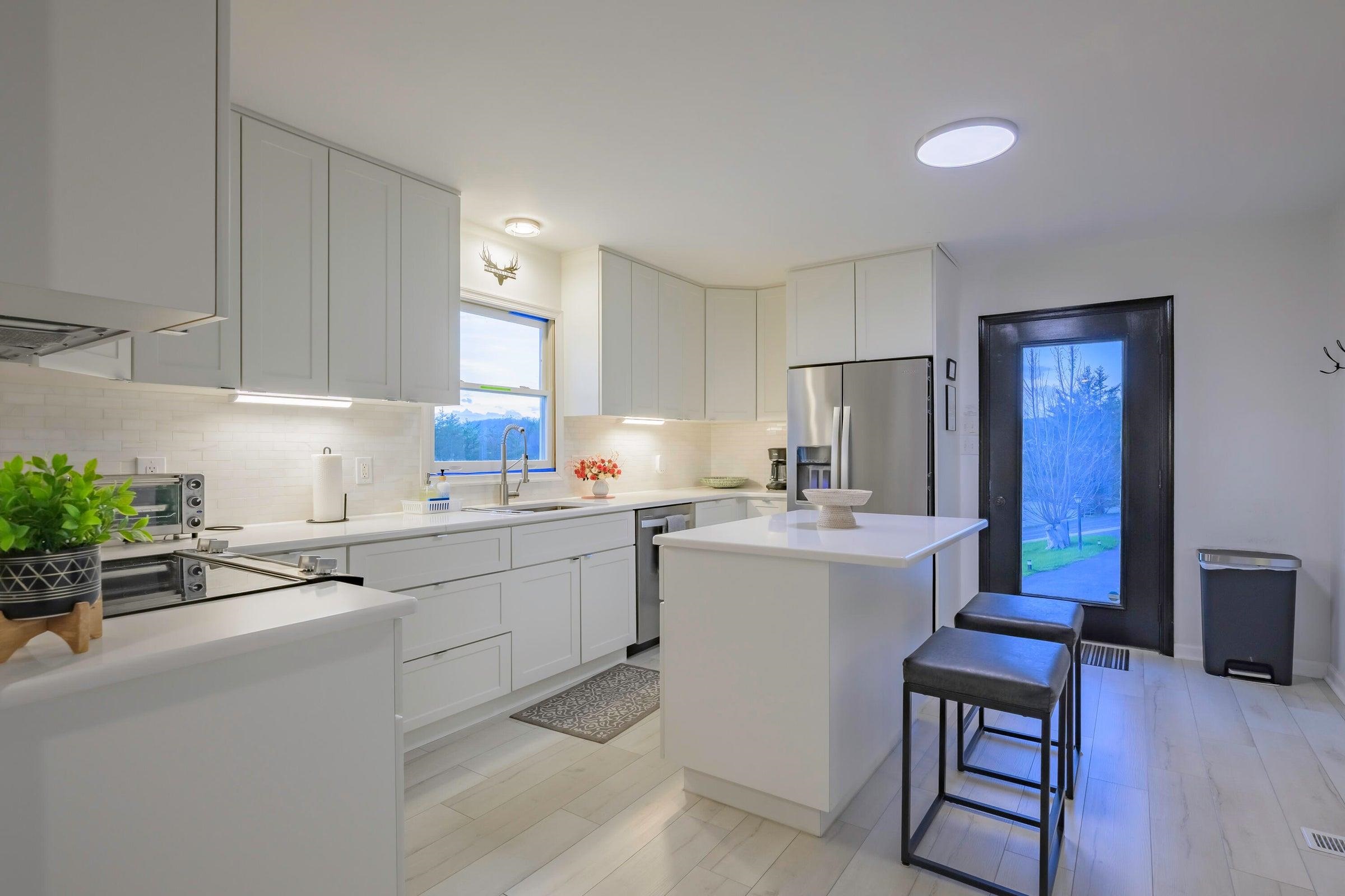 Quartz counter tops. Convenient island.