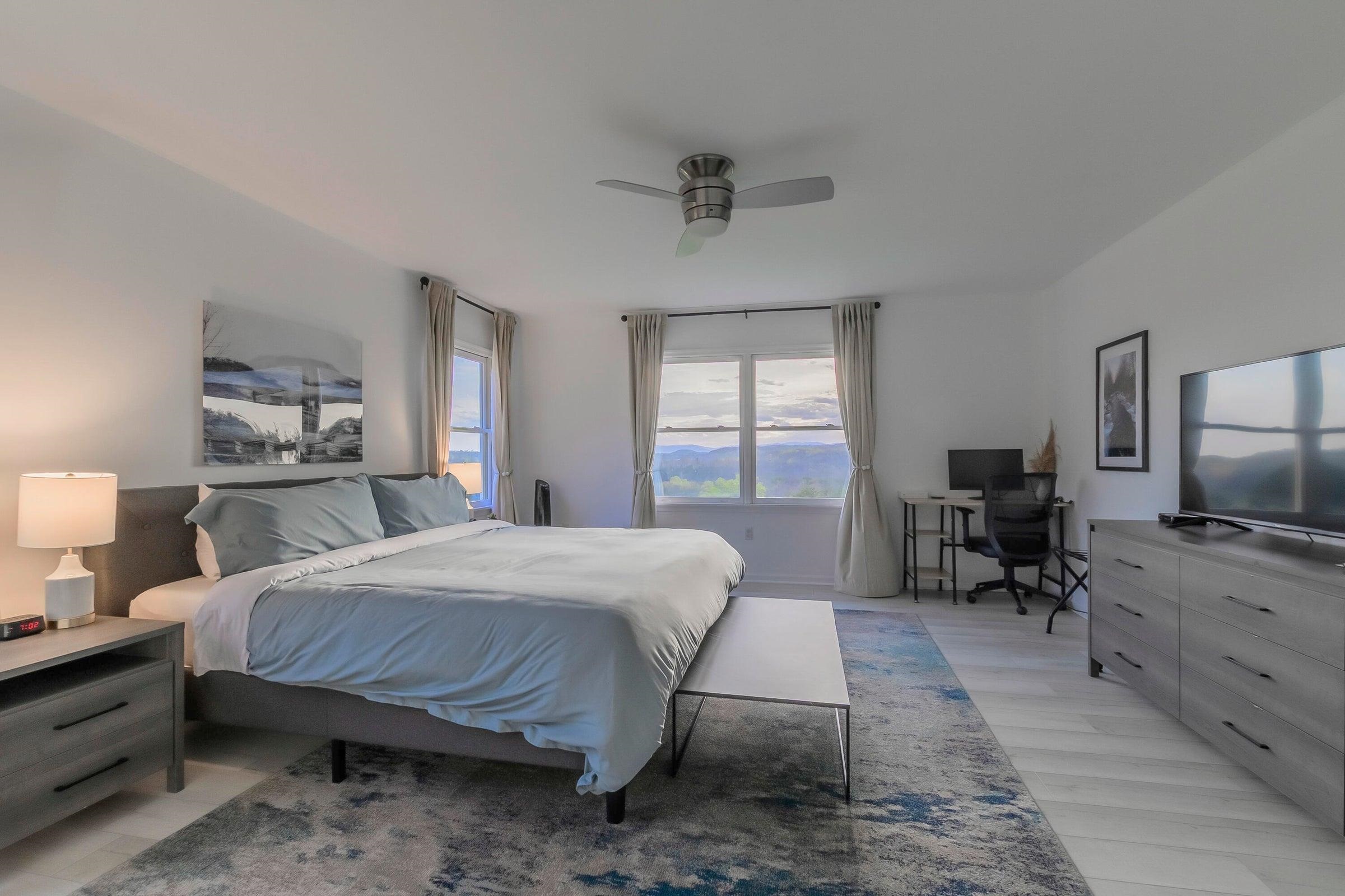 Master Bedroom with ceiling fan and light.