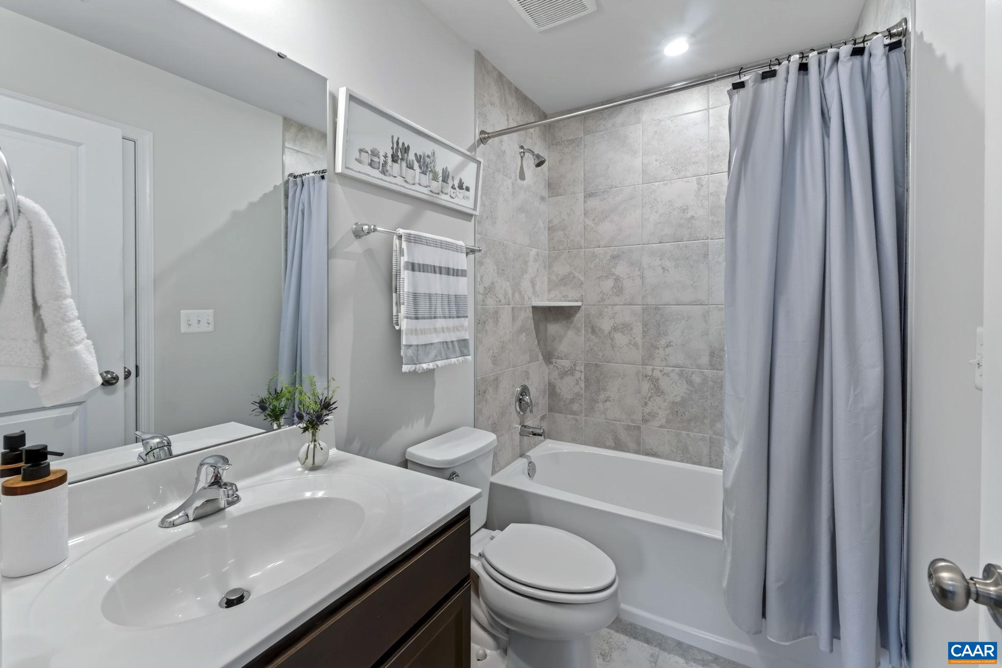 Well appointed with tile flooring and shower walls Well appointed with tile flooring and shower walls