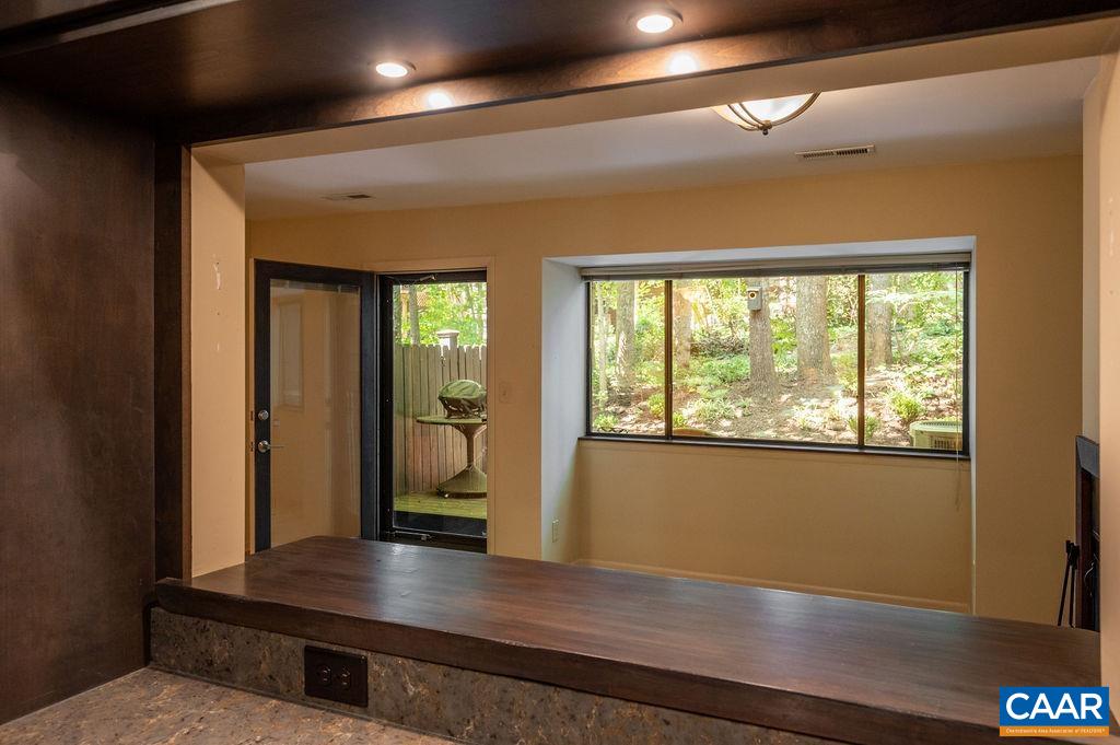 View from the kitchen sink into the living room and the patio beyond. View from the kitchen sink into the living room and the patio beyond.