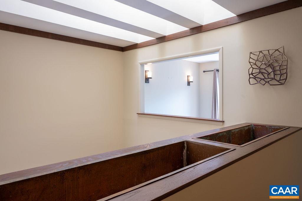 Second floor hall is open to the skylights in the dining area below and there are installed planter boxes to take advantage of the natural light Second floor hall is open to the skylights in the dining area below and there are installed planter boxes to take advantage of the natural light