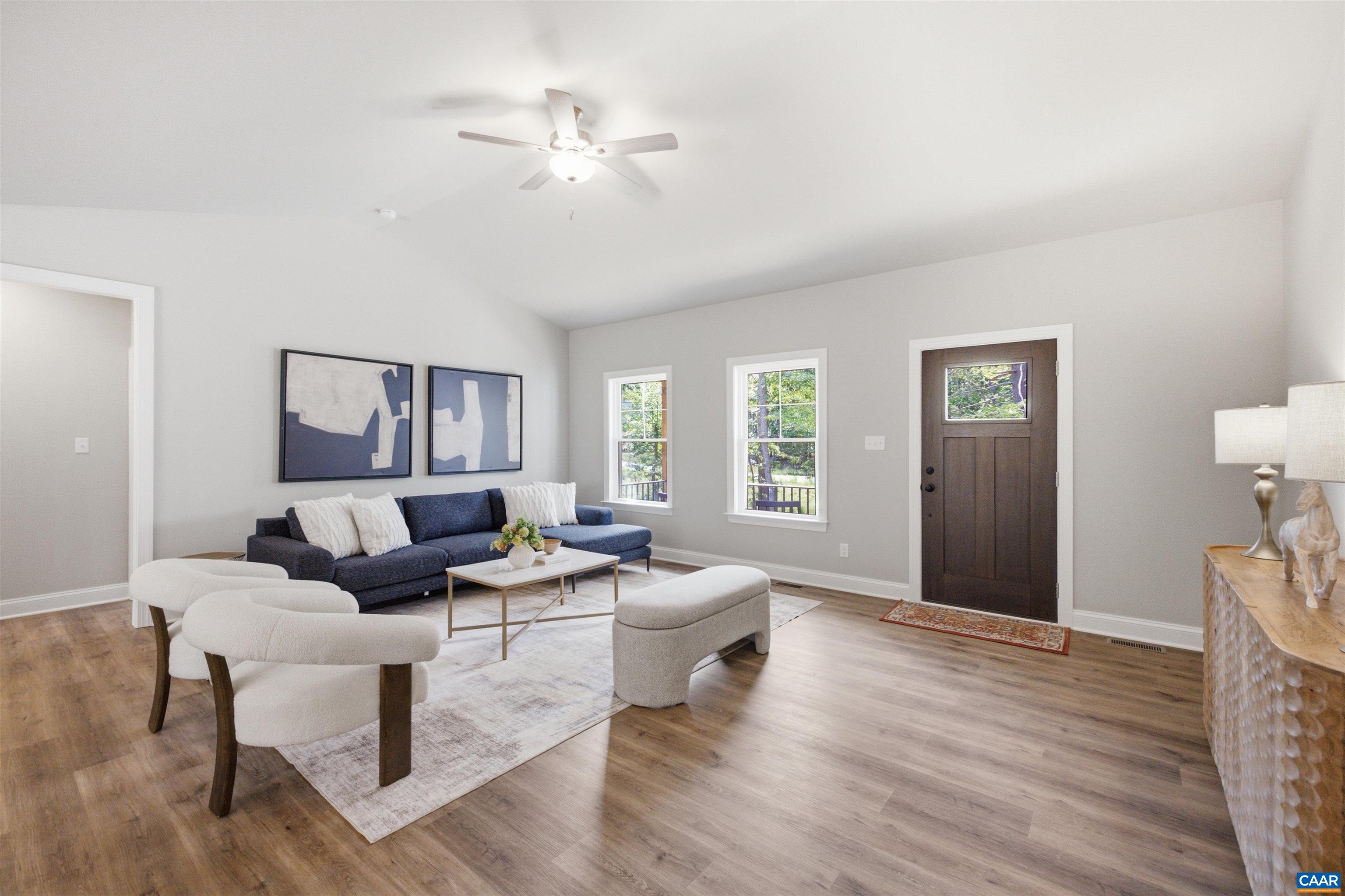 Vaulted Ceiling, hall to secondary bedrooms, full bath.  Photo of for-sale home, staged.