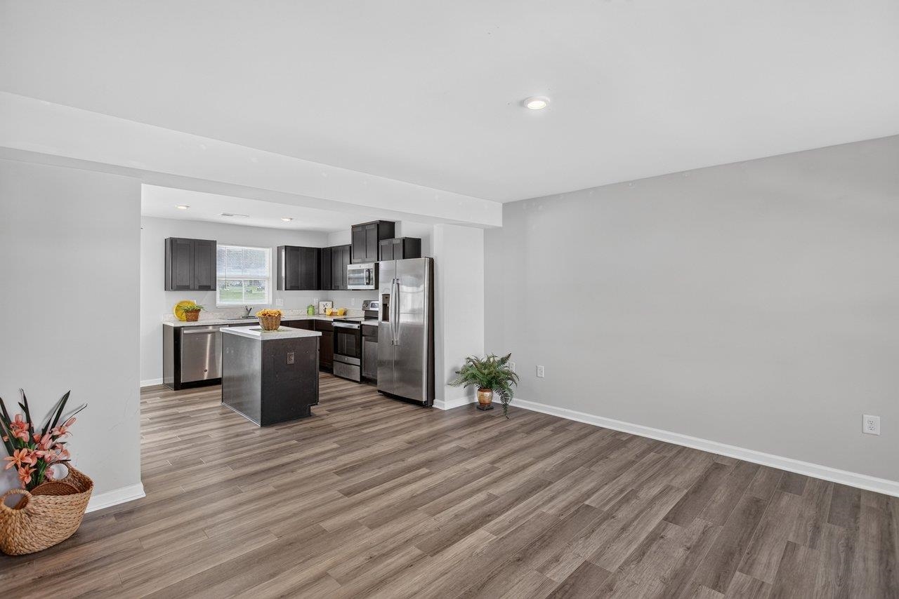 This spacious living area flows into the kitchen and dining area