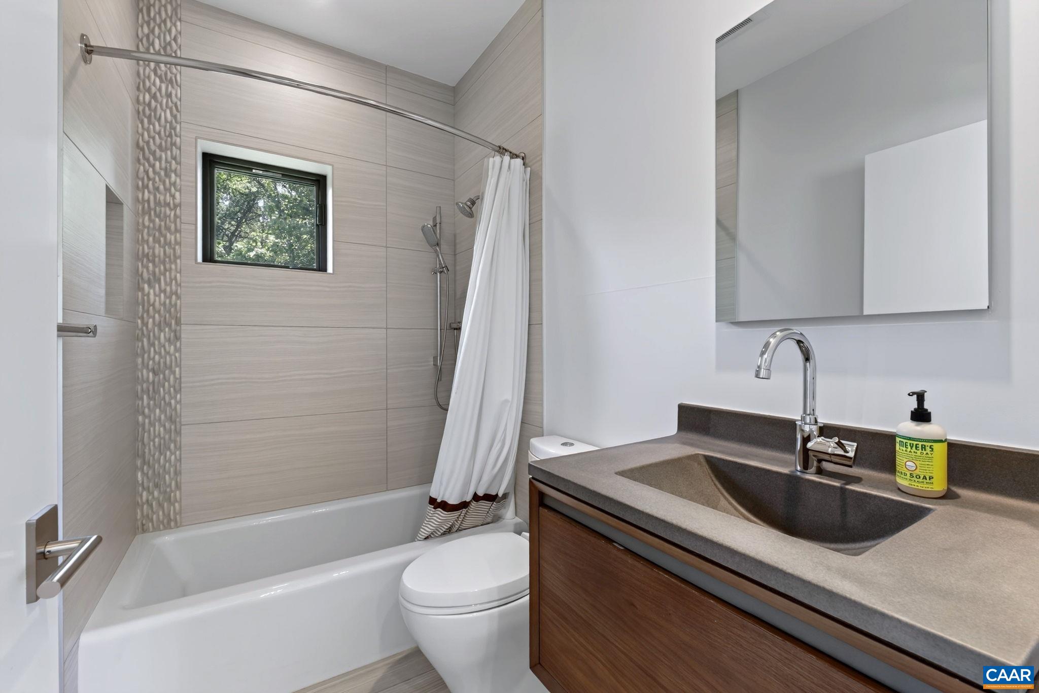 Fully tiled upstairs bath with stone shower accent and one piece stone sinks. Fully tiled upstairs bath with stone shower accent and one piece stone sinks.