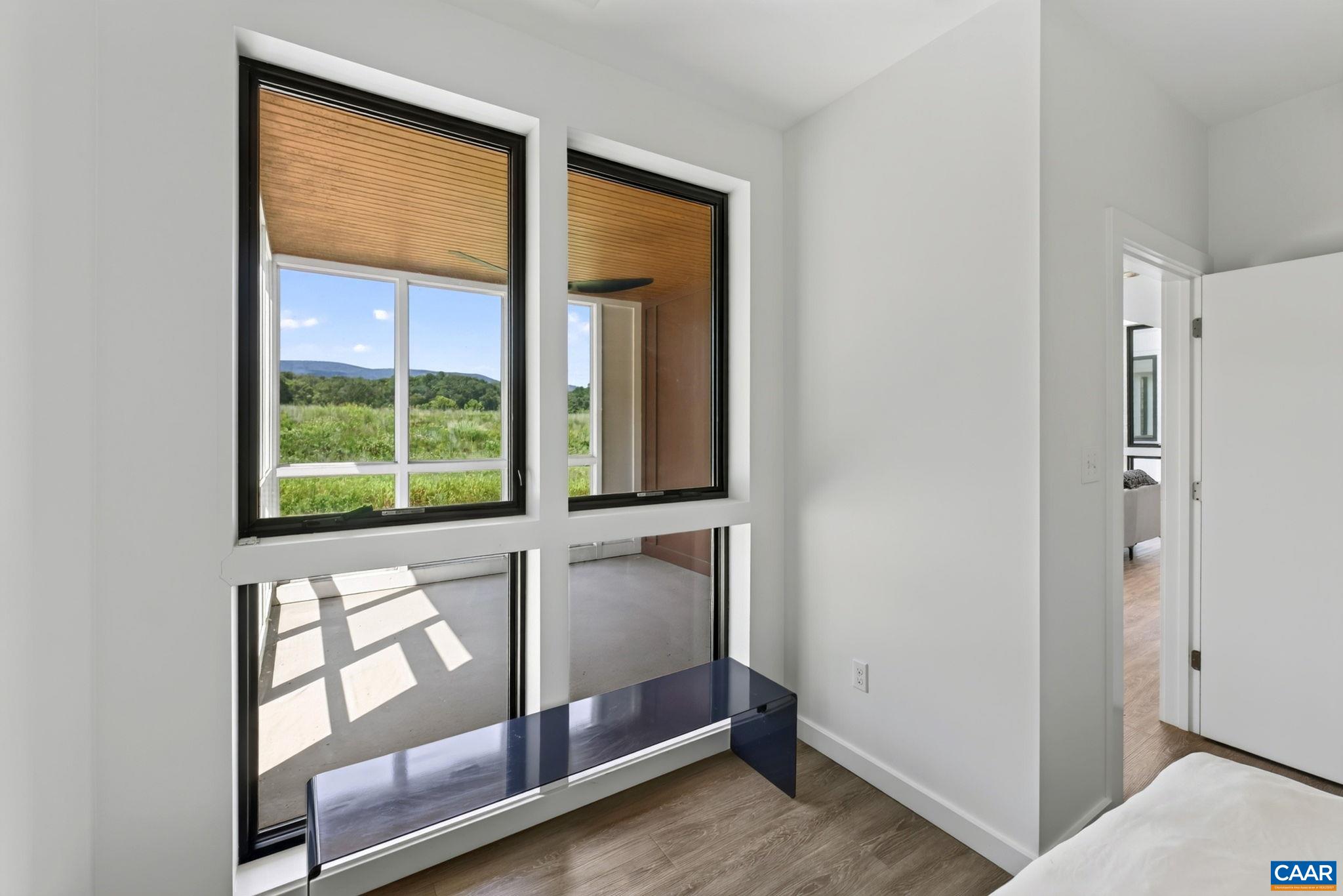 Bedroom view into the screen porch and mountains beyond. Bedroom view into the screen porch and mountains beyond.