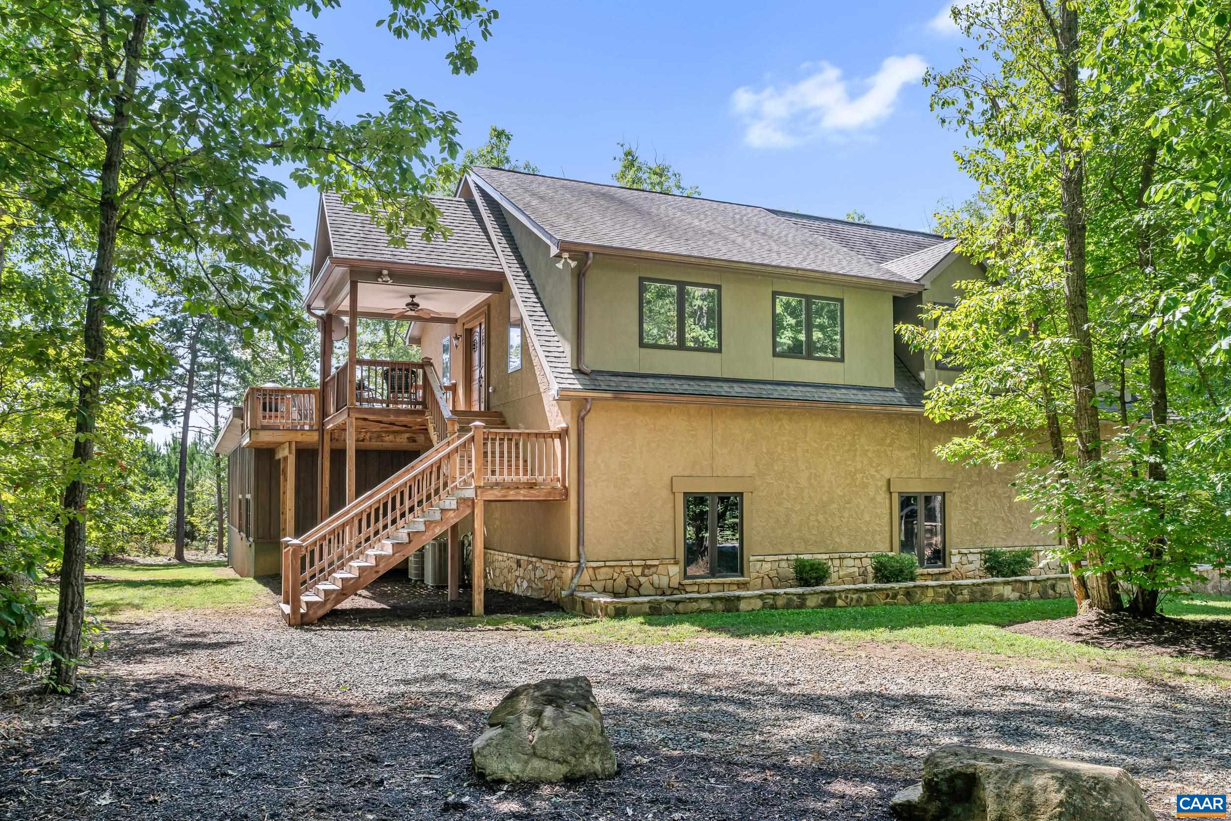 Beautiful Country Estate surrounded by mature trees and exceptional privacy, showcasing the home's distinctive stone and stucco exterior Beautiful Country Estate surrounded by mature trees and exceptional privacy, showcasing the home's distinctive stone and stucco exterior