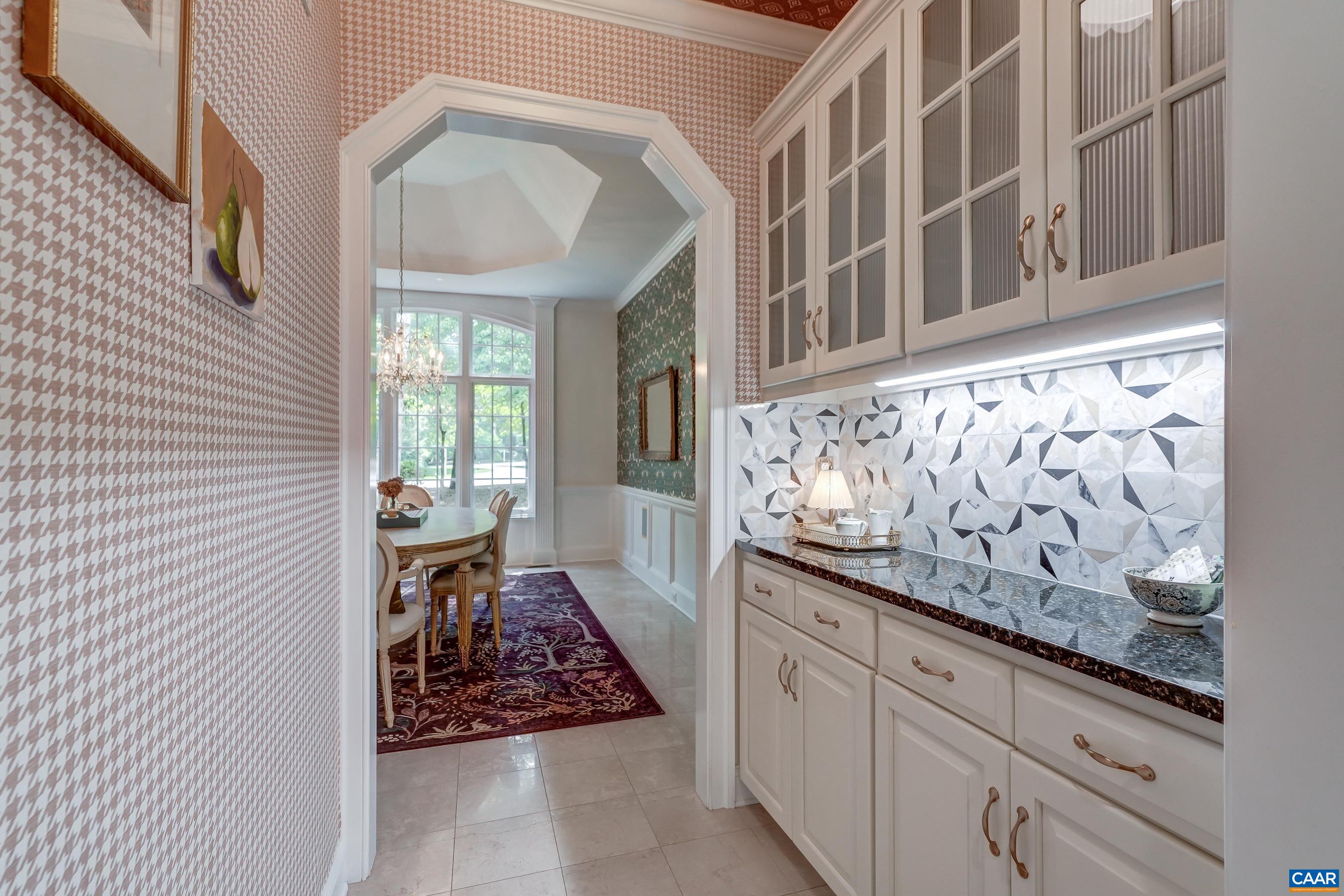 Butlers pantry with glass cabinets, beautiful tile work and custom wall covering. Butlers pantry with glass cabinets, beautiful tile work and custom wall covering.