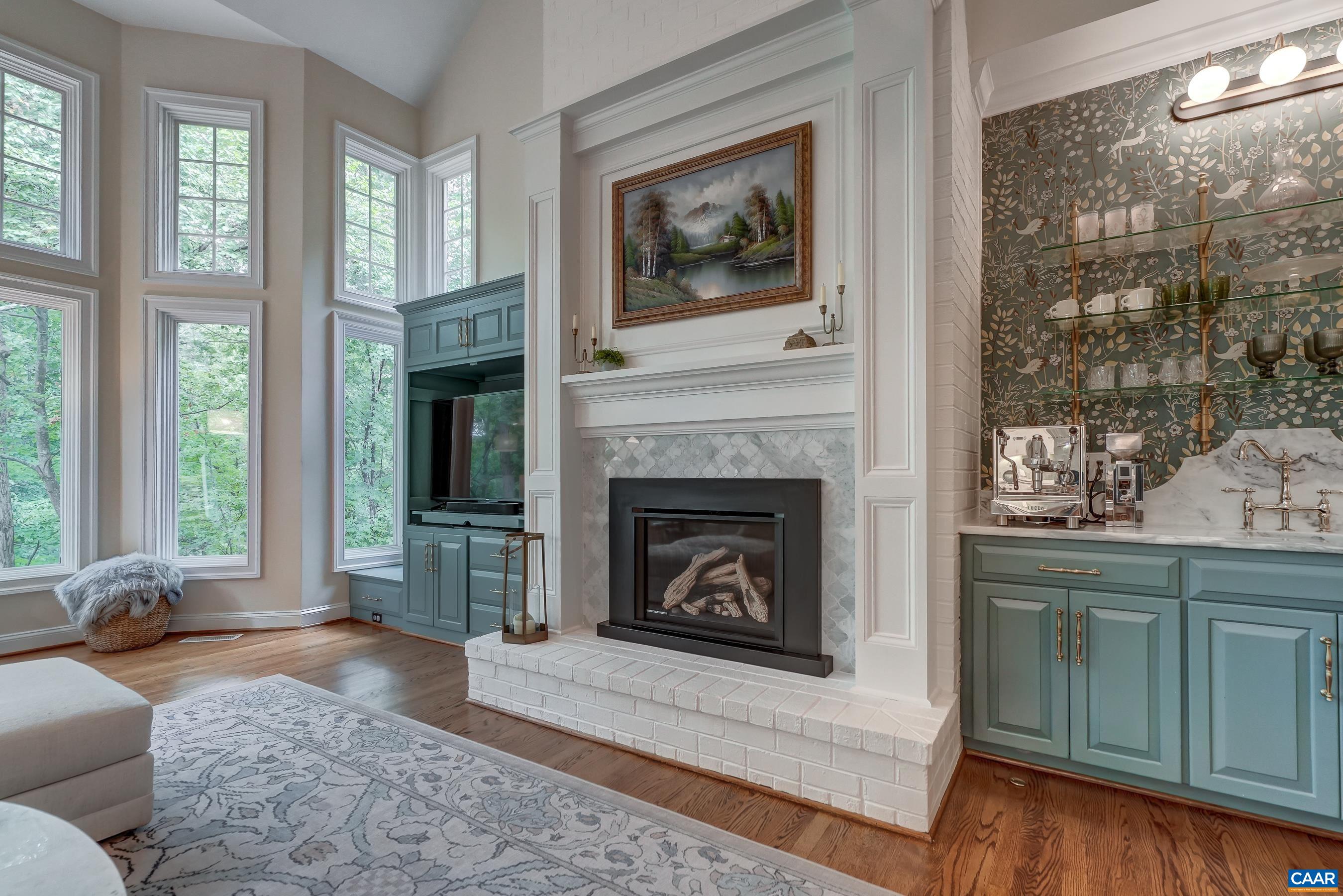 Gas fireplace framed by custom built-in cabinetry. Gas fireplace framed by custom built-in cabinetry.