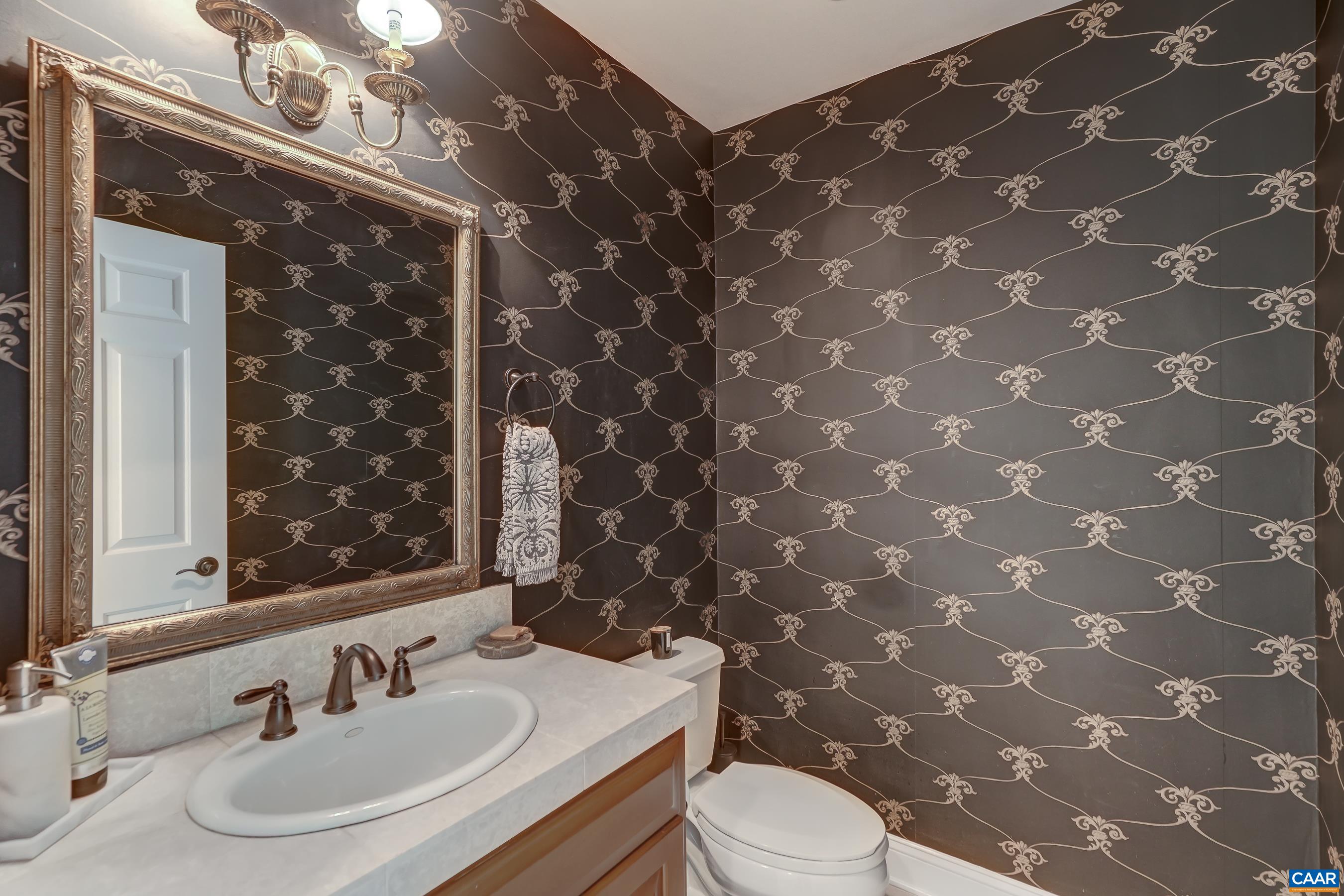 Half bathroom with custom wall covering. Half bathroom with custom wall covering.