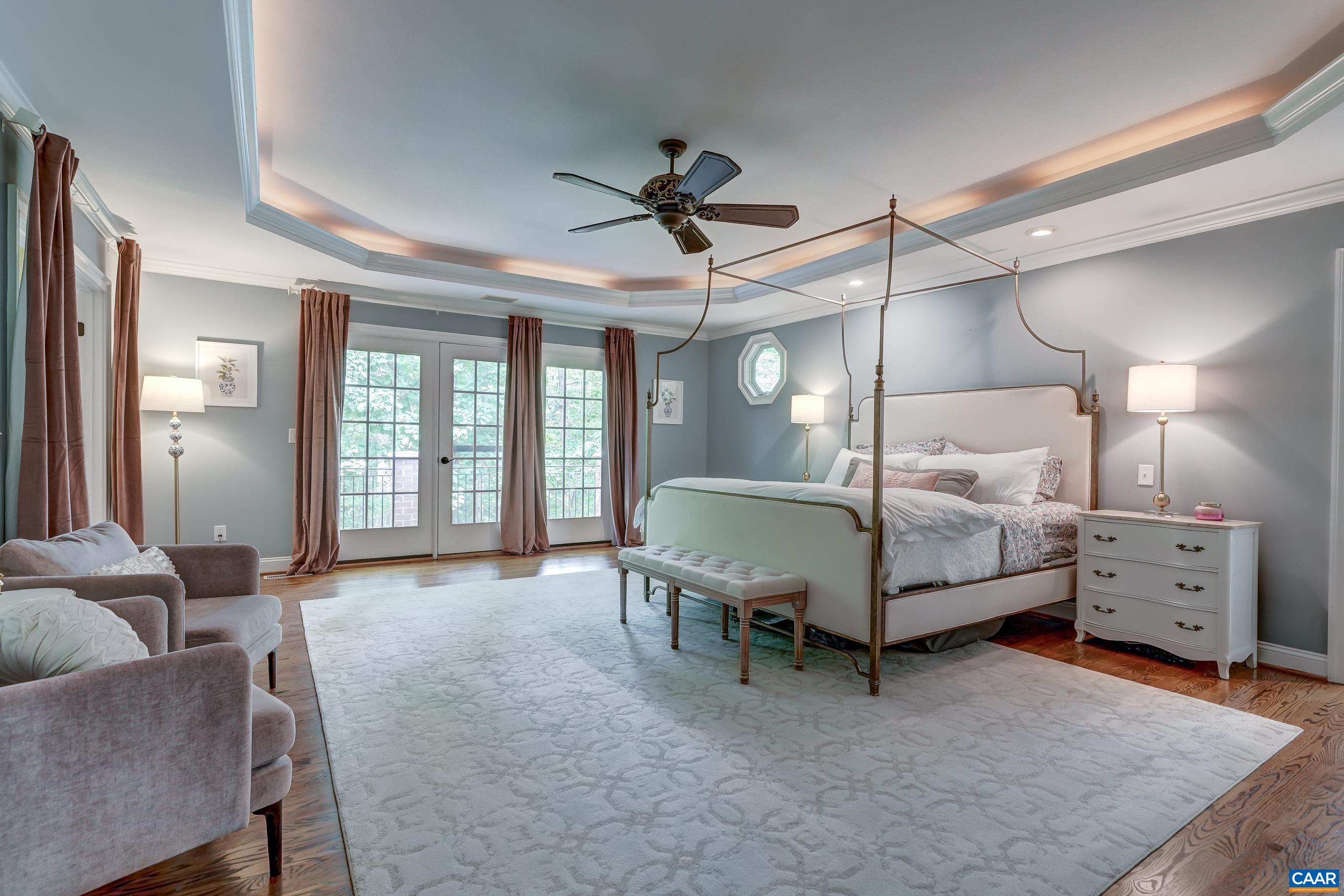Main level primary suite features tray ceiling with accent lighting. Main level primary suite features tray ceiling with accent lighting.