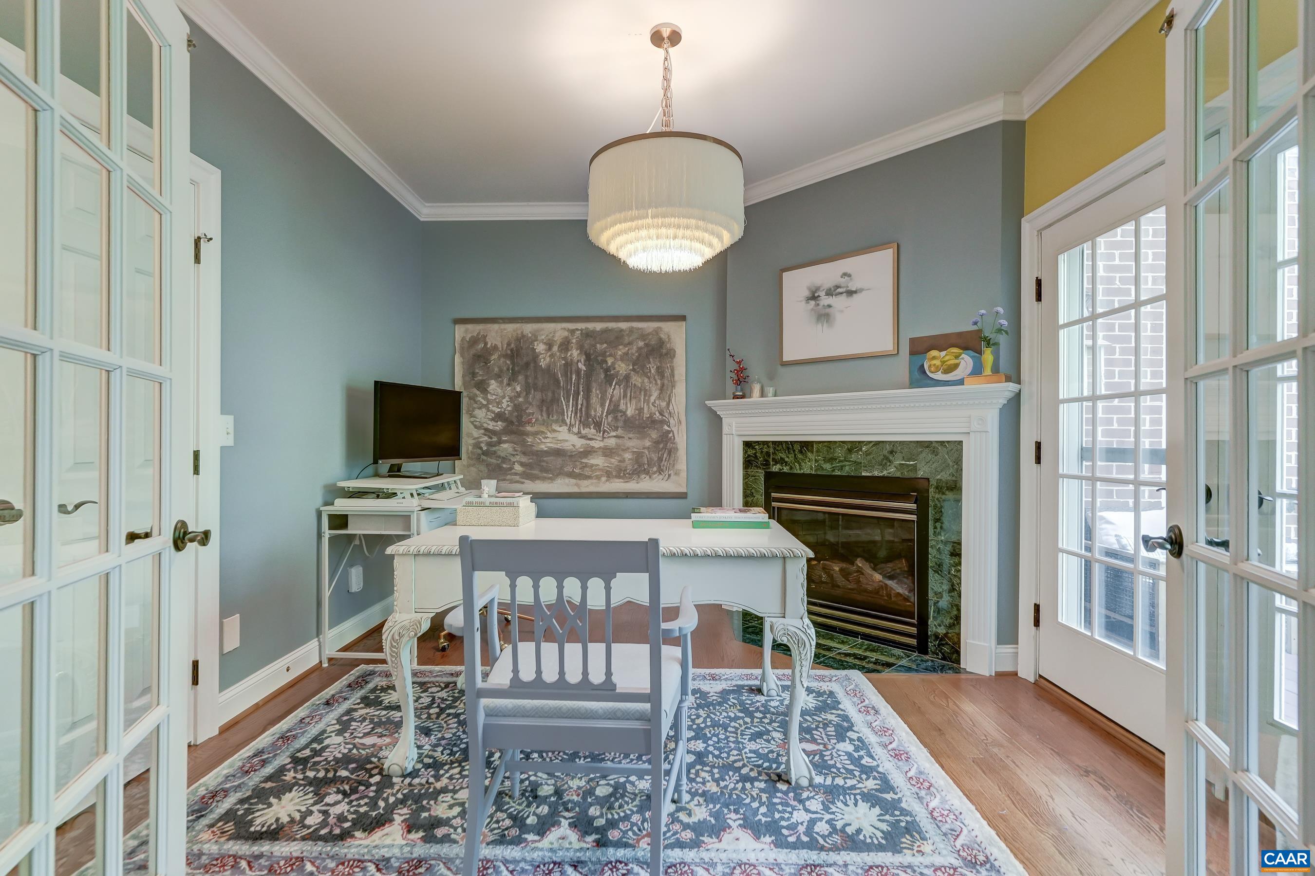 Primary sitting room/home office features a gas fireplace and access to the deck. Primary sitting room/home office features a gas fireplace and access to the deck.
