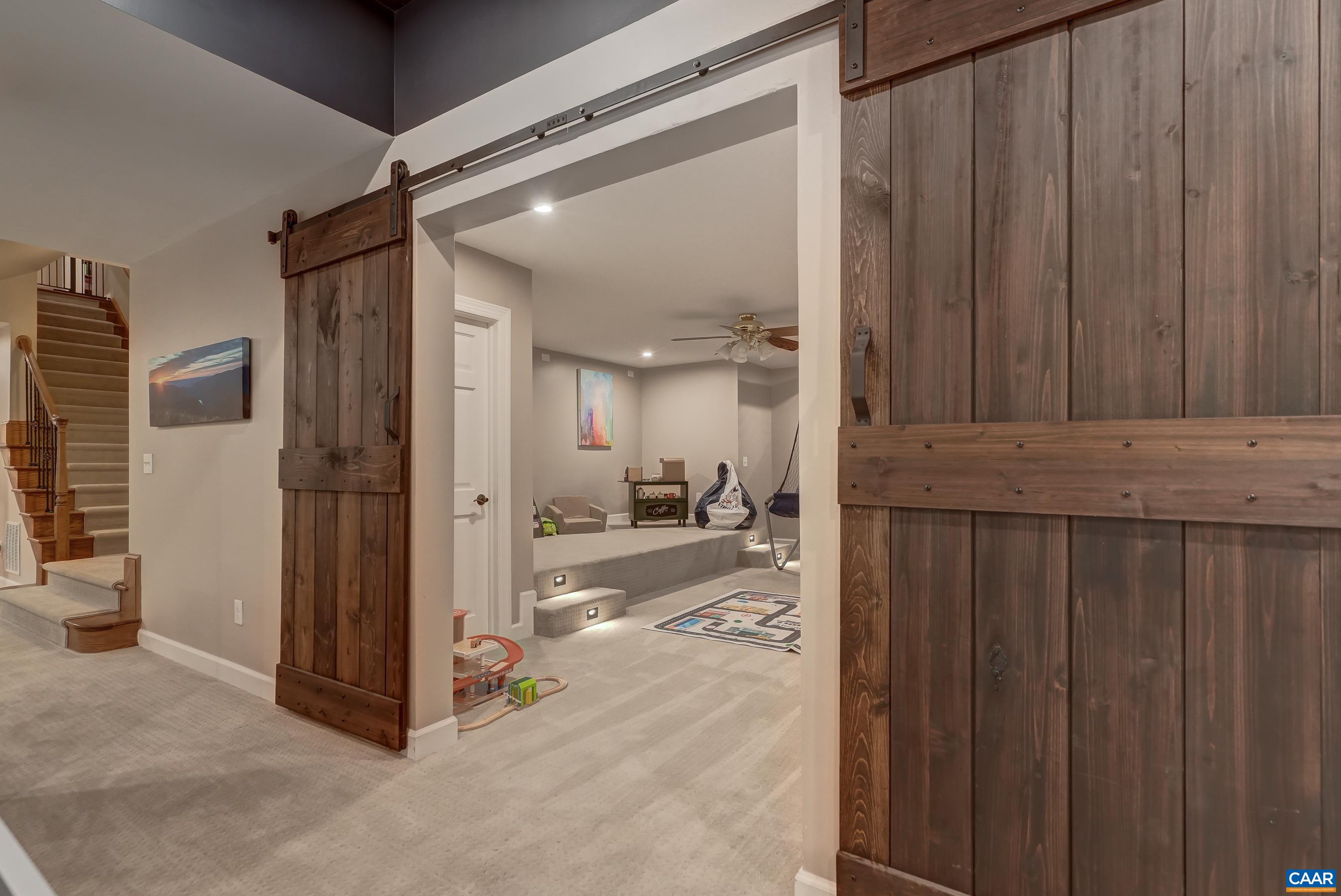 Sliding barn doors separate a play space from the main living area. Sliding barn doors separate a play space from the main living area.