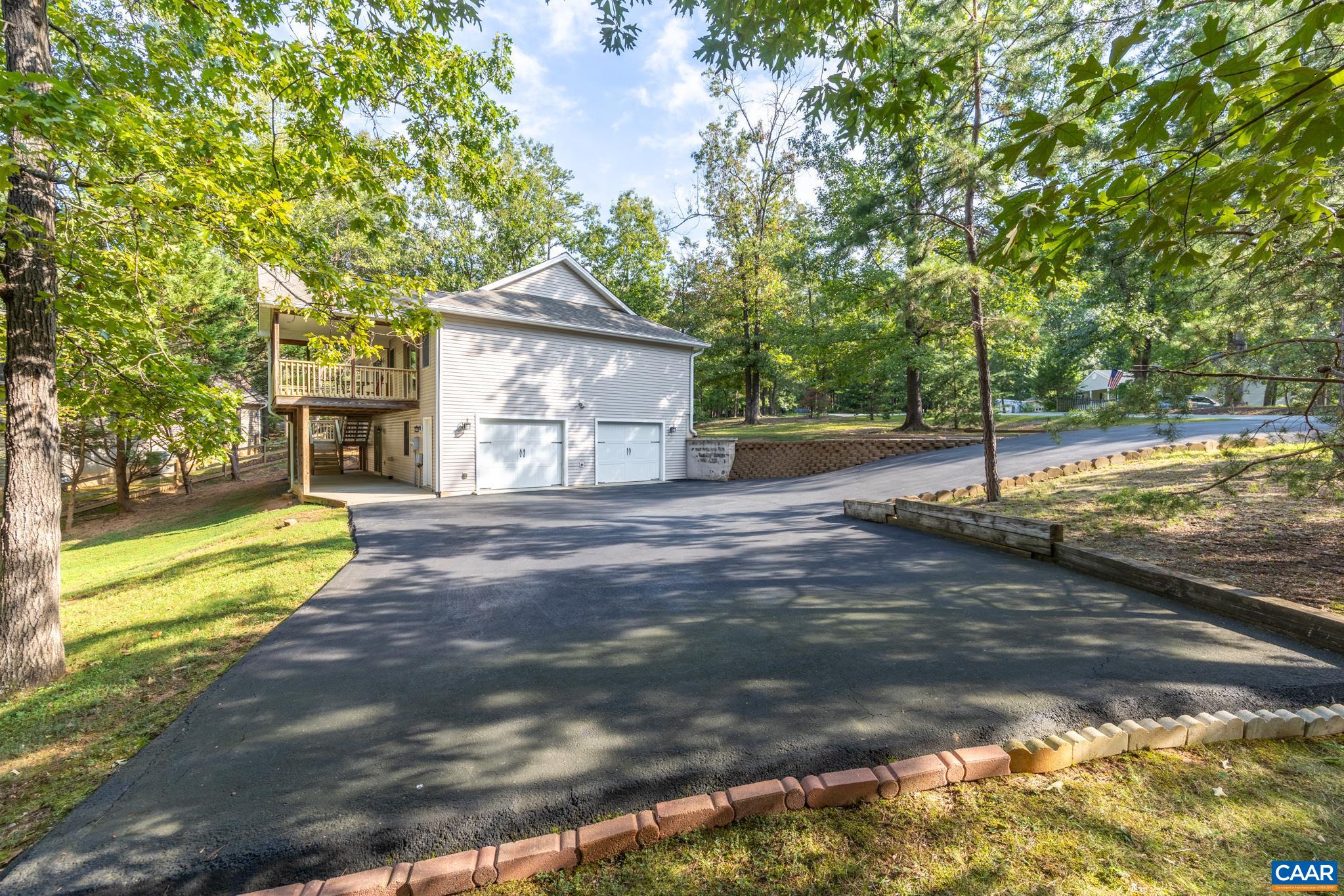 This paved driveway offers plenty of off road parking for vehicles, boats and RV's.