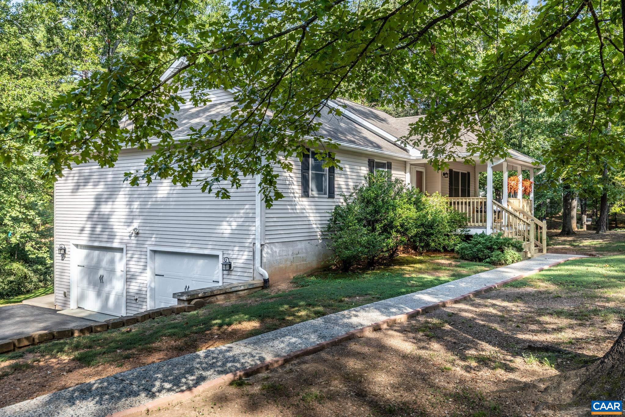 The paved driveway leads to a side entry oversized 2 car garage