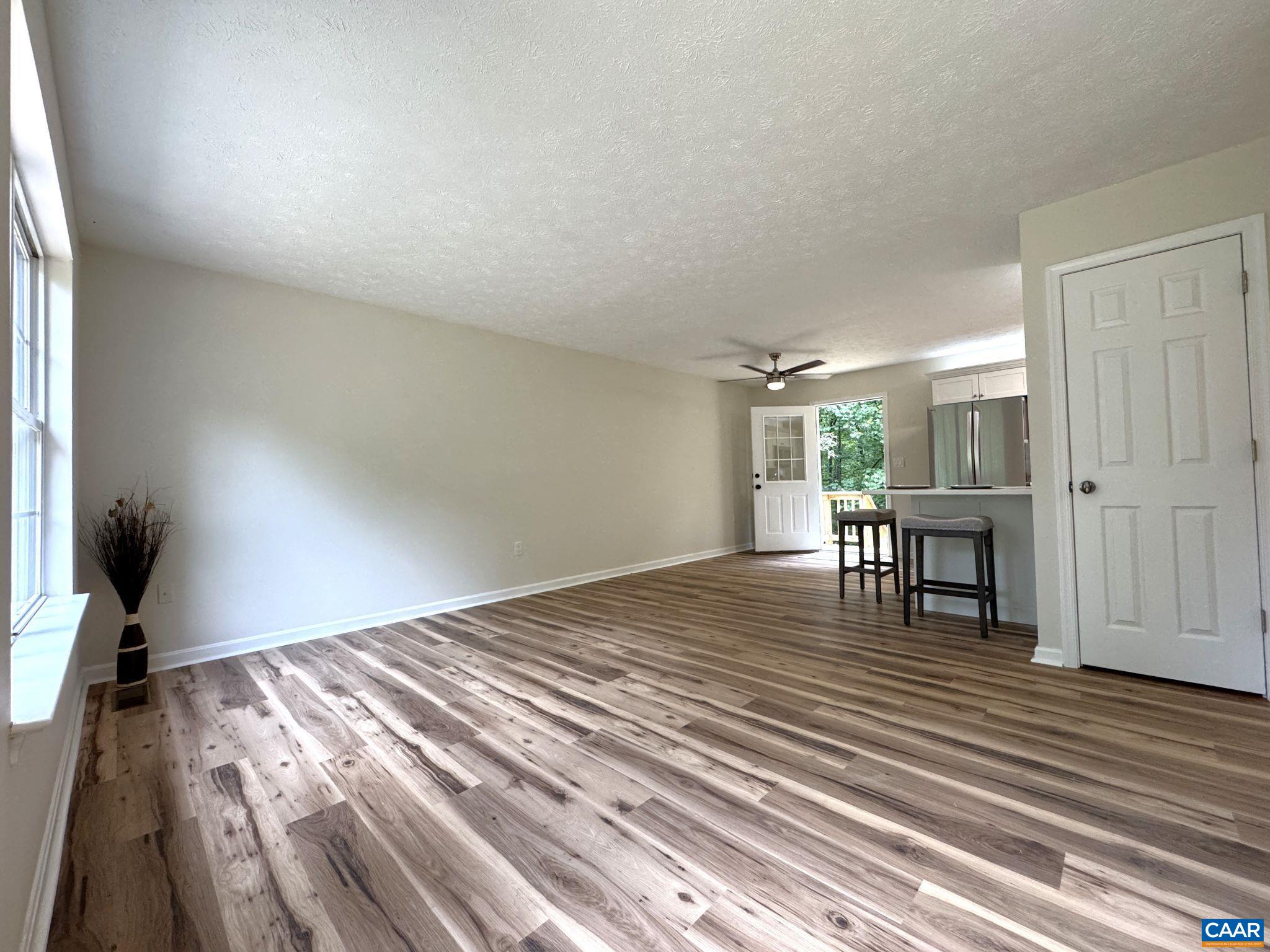 Large Open Living Room - Custom Lighting and Luxury Vinyl Plank throughout