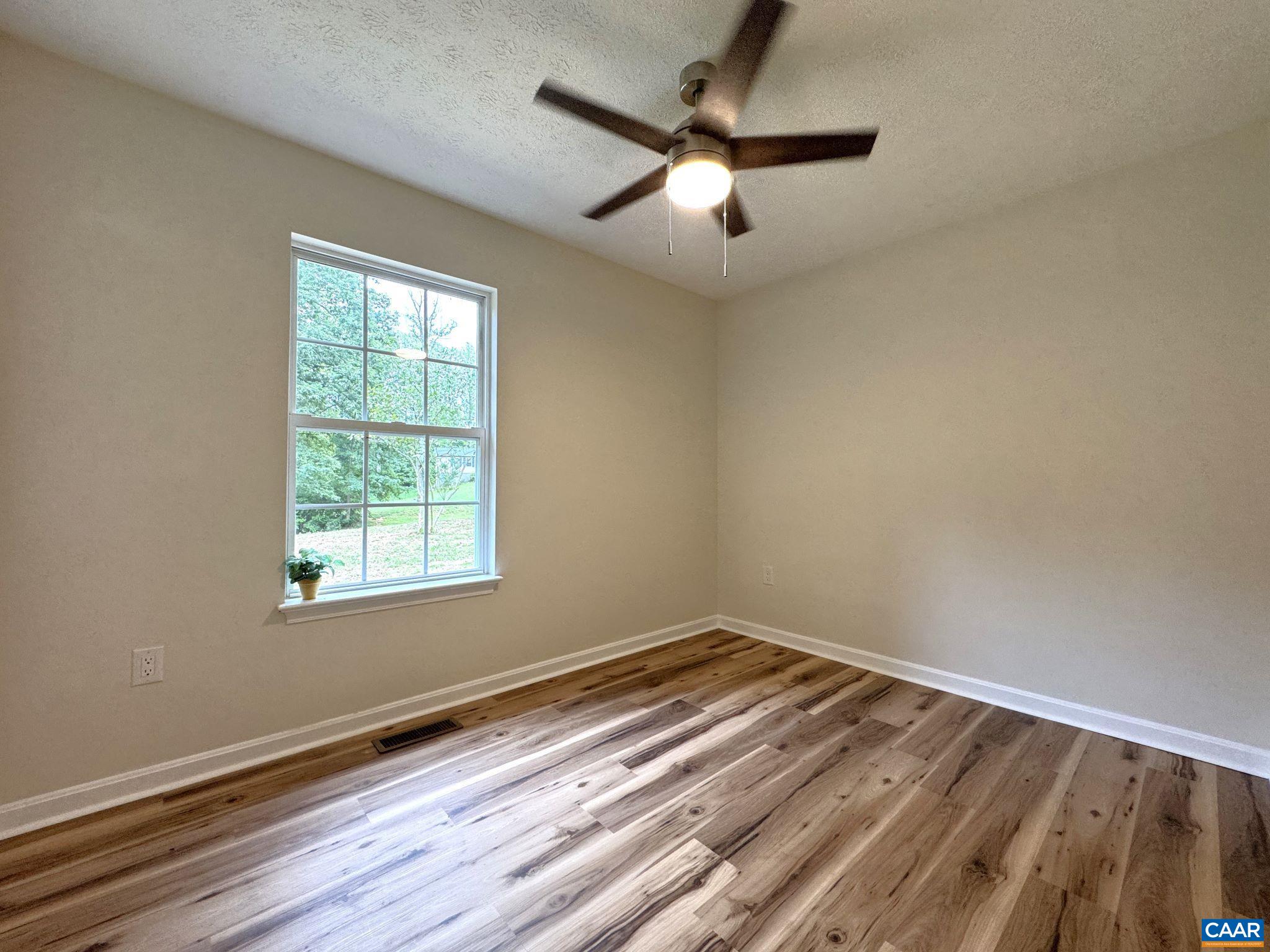 Bedroom 1 of 3 - Custom Ceiling Fan, LVP flooring