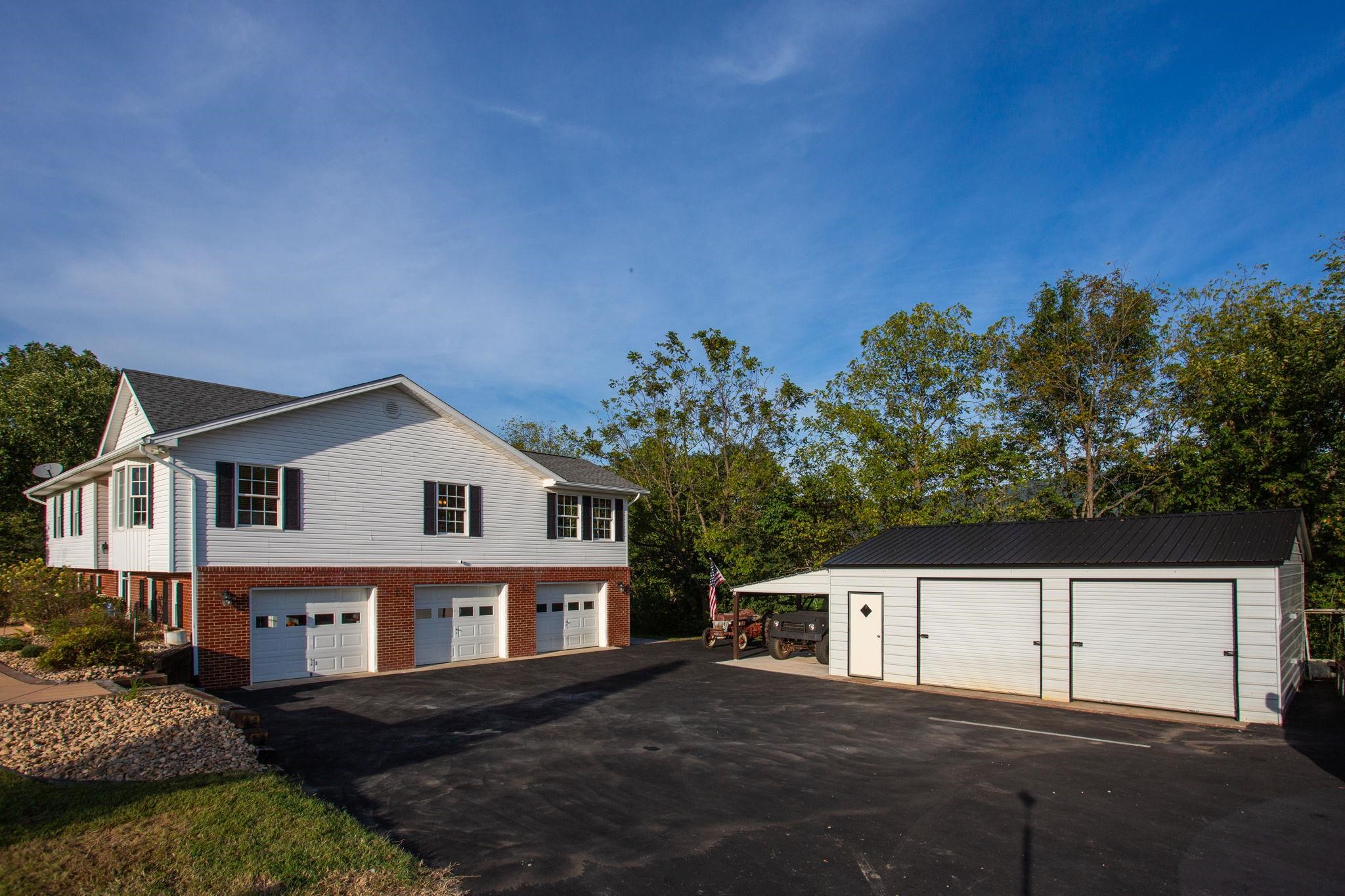 3-Car Attached Garage and 2-Bay Detached Garage, Workshop and Large Lean.