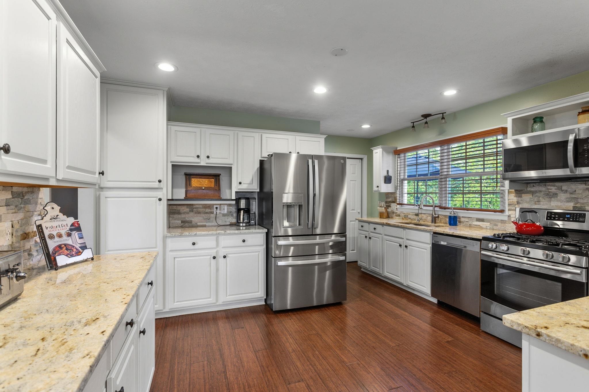 with new appliances and granite countertop.