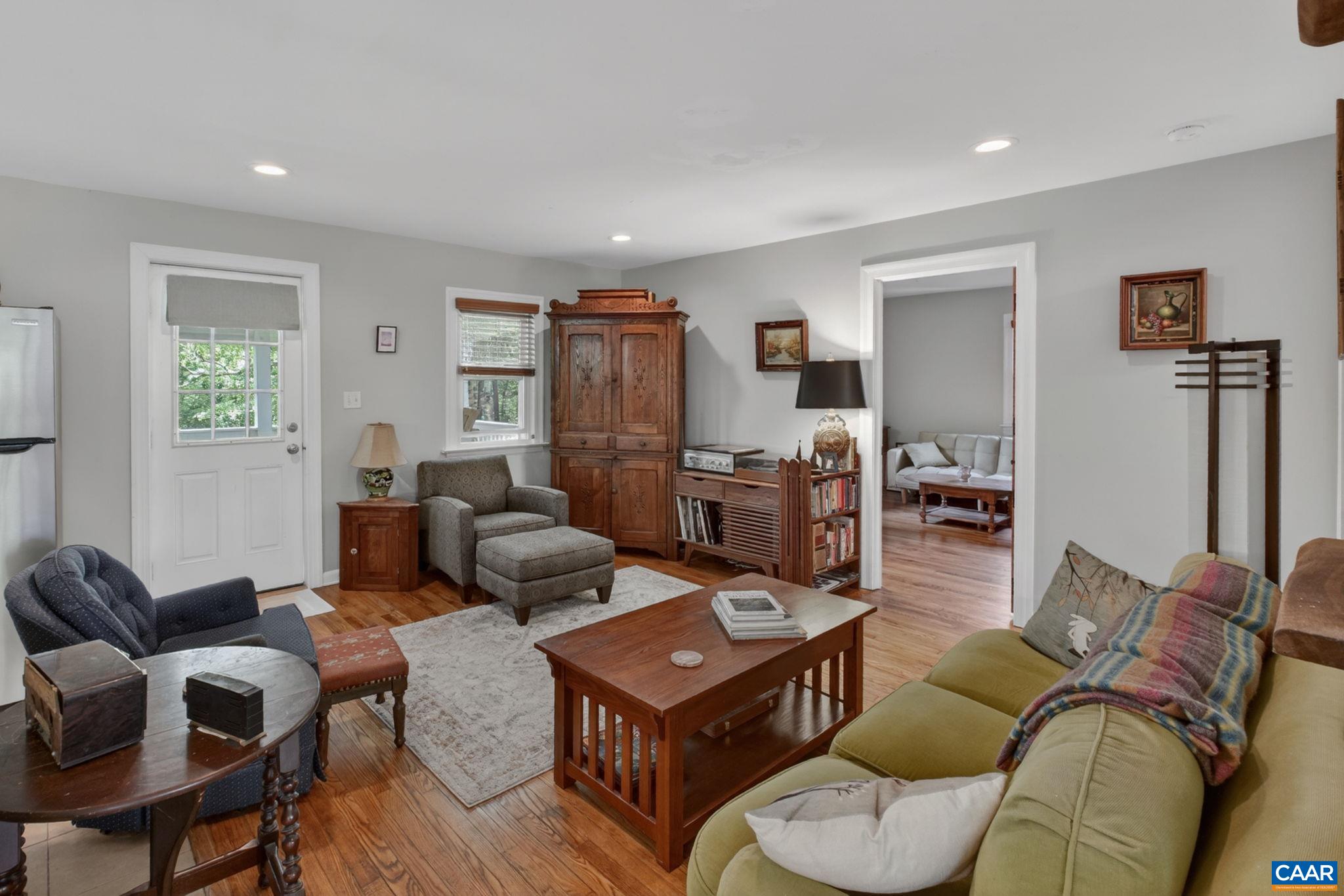 Living room, front door, and door to bedroom.