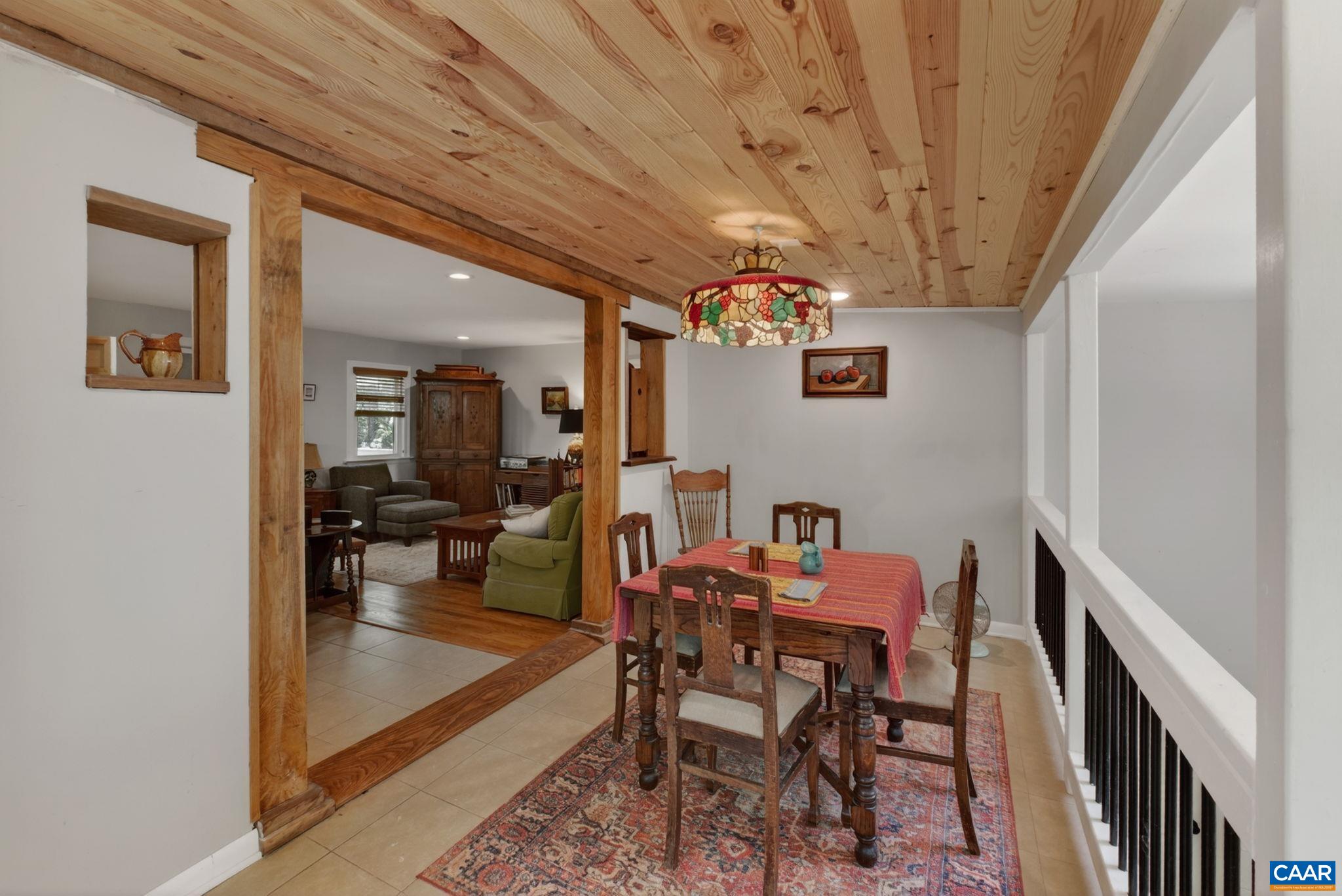Dining room with railing besides the stairs to the basement.